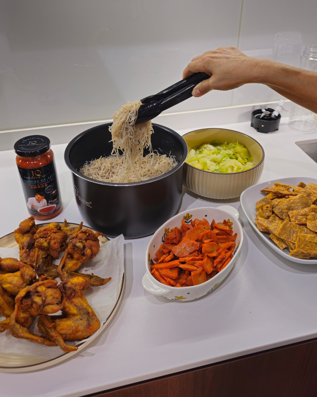 Hosting at Home: From 2 to 22  - fried noodles, black pot, black tongs, rice noodles, black container, black lid, black