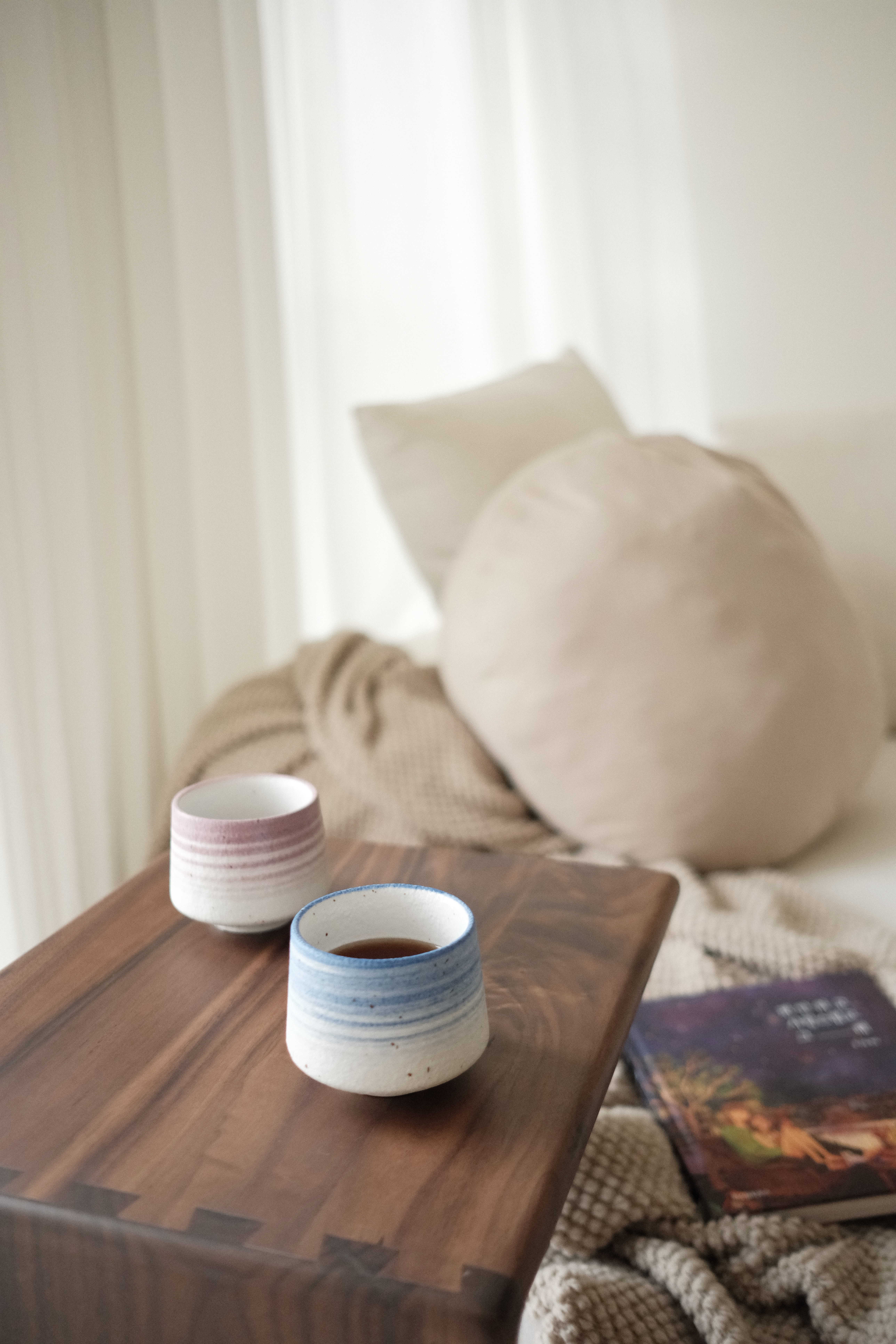 Slow Mornings And Quiet Comfort: My Weekend Routine - wooden table, ceramic cups, minimalist decor, cozy room, soft lighting