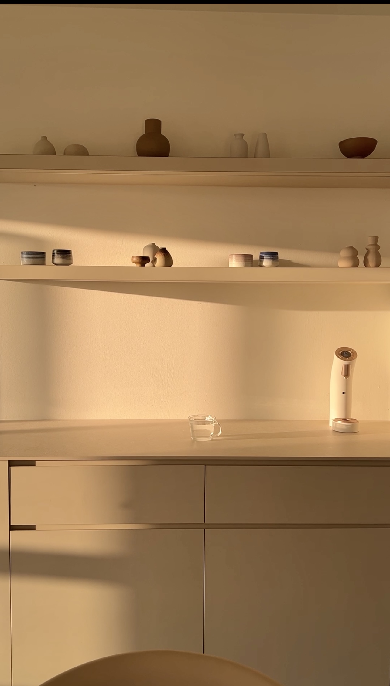 My Best Home Investments: The Luxuries I Didn't Know I Needed - Shelf with various ceramic items, minimalist decor, soft