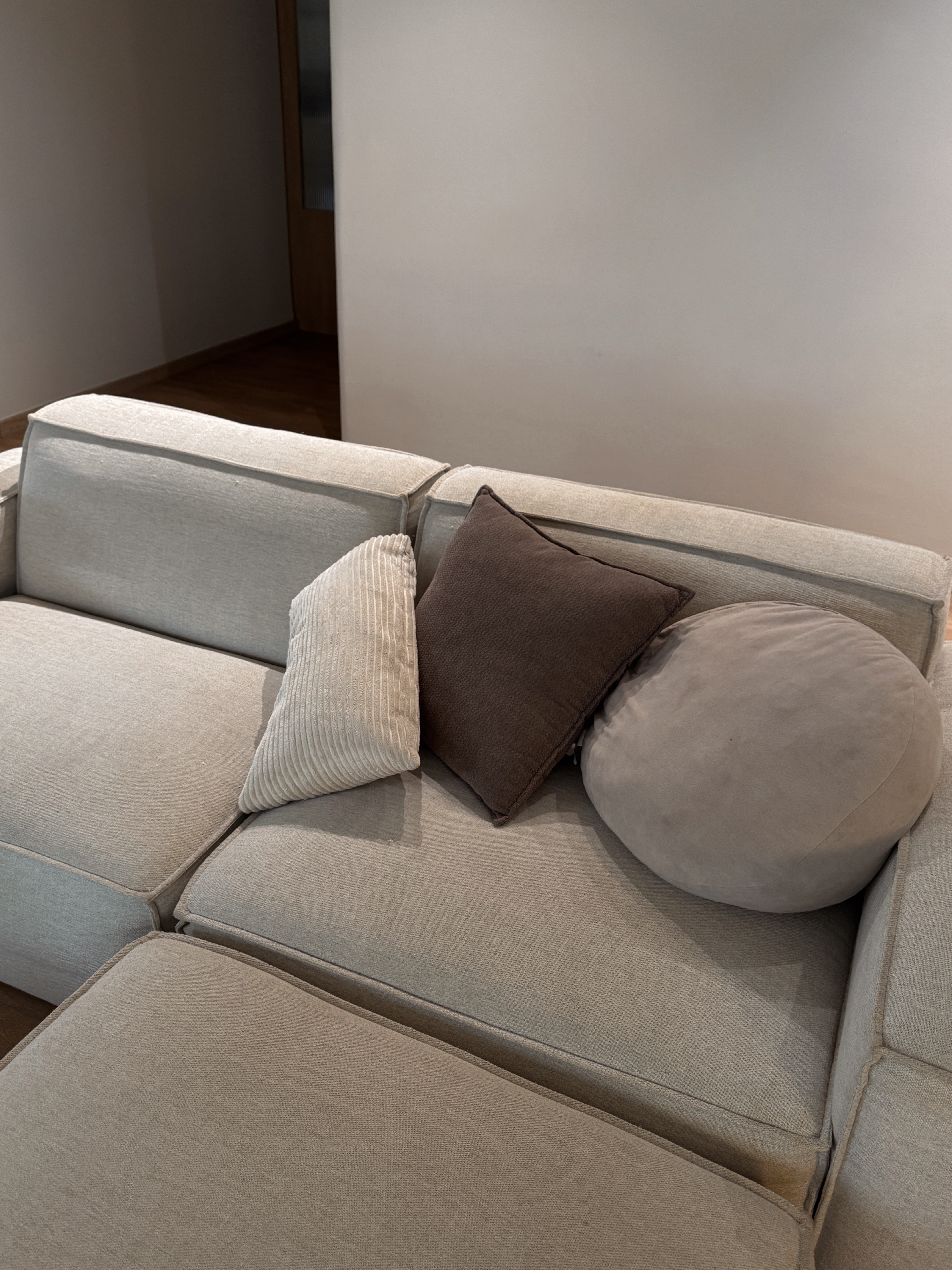 Hosting Tips to Make Guests Feel at Home - Light gray sofa, beige upholstery, modern design, cozy seating, soft cushions