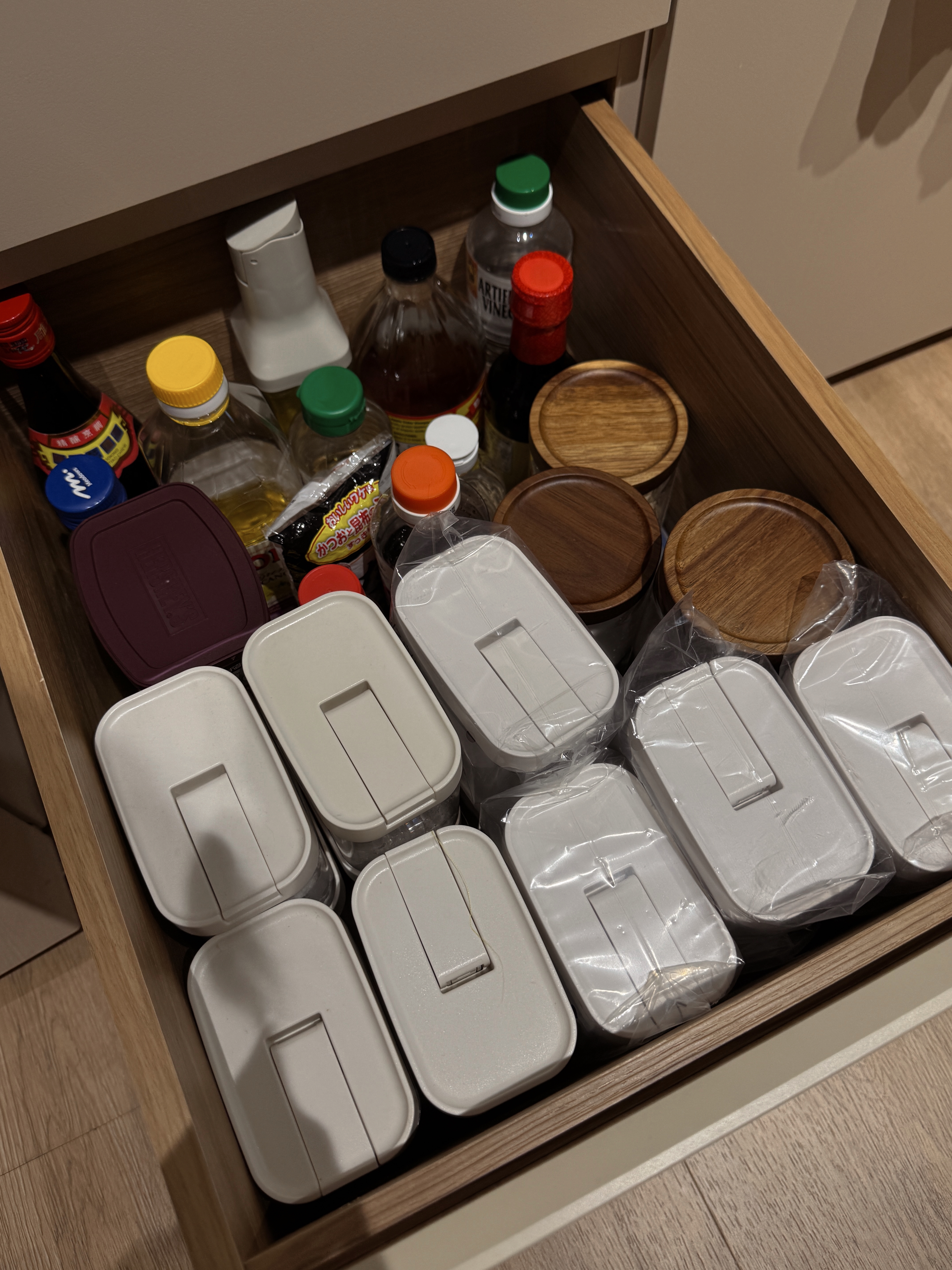 Home Organization We Love - Wooden drawer, neatly organized, various bottles, soy sauce, vinegar, rice vinegar, cooking oil