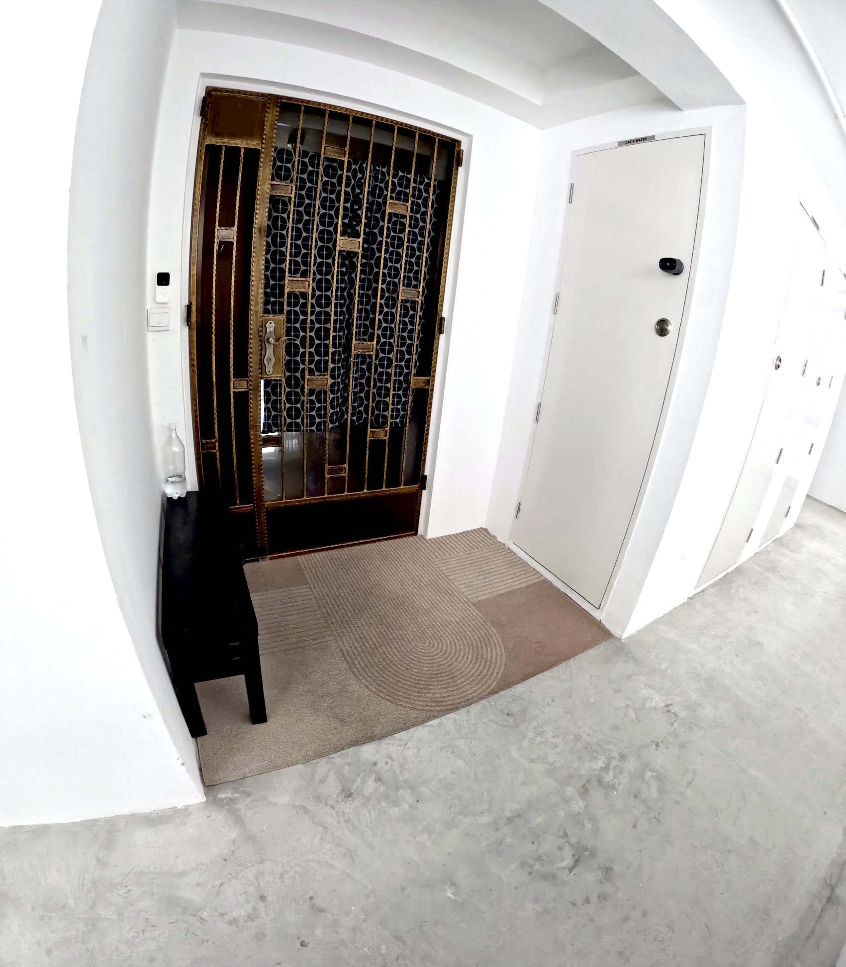 Urban Oasis: A Plant-Filled Corridor with a Bicycle Rack 🌿🚲 - White hallway, modern design, white walls, arched doorway