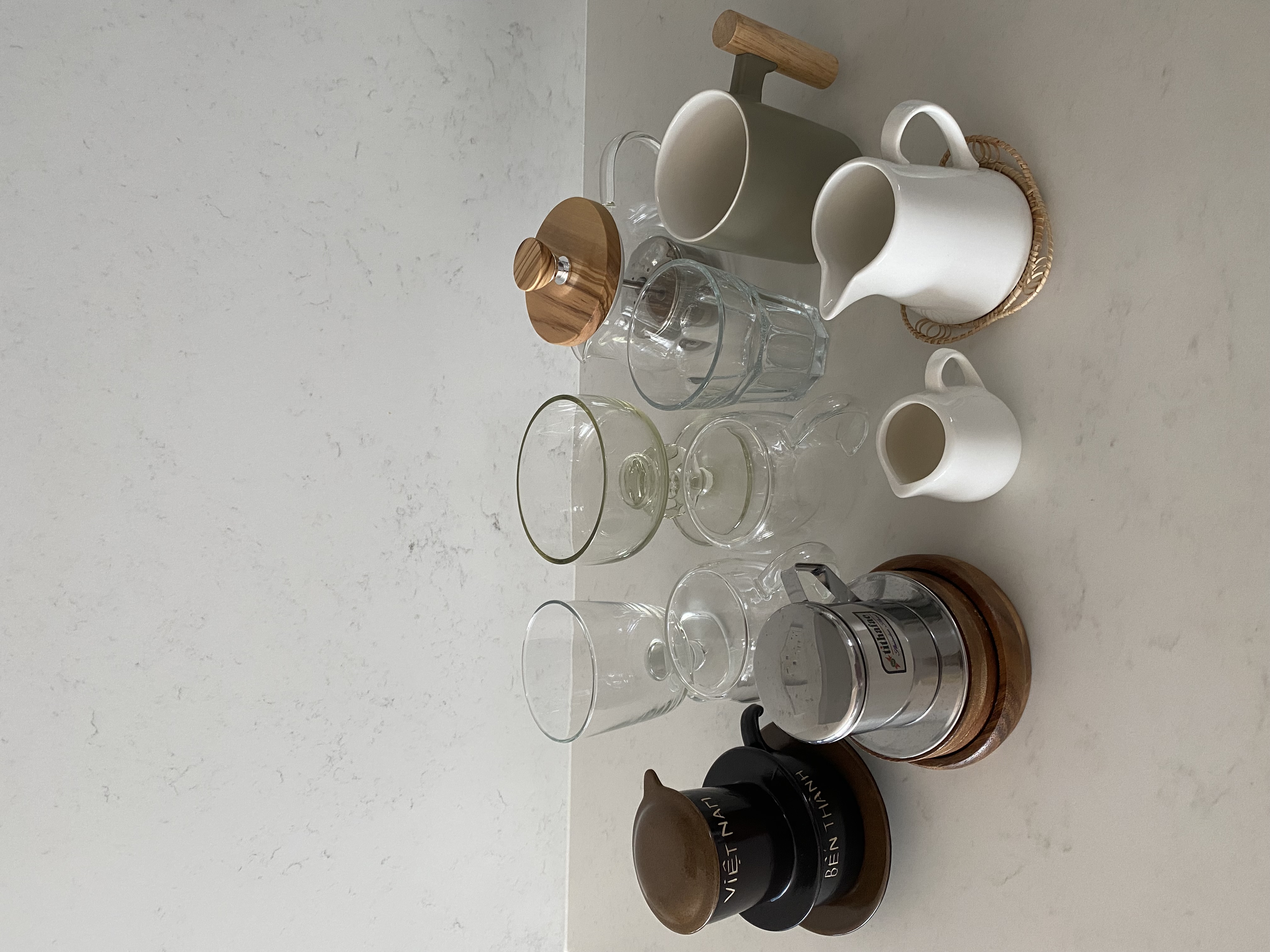 Aesthetic decorative, functional homewares at our place - Clear glass cups, white ceramic pitcher, wooden handle, metallic