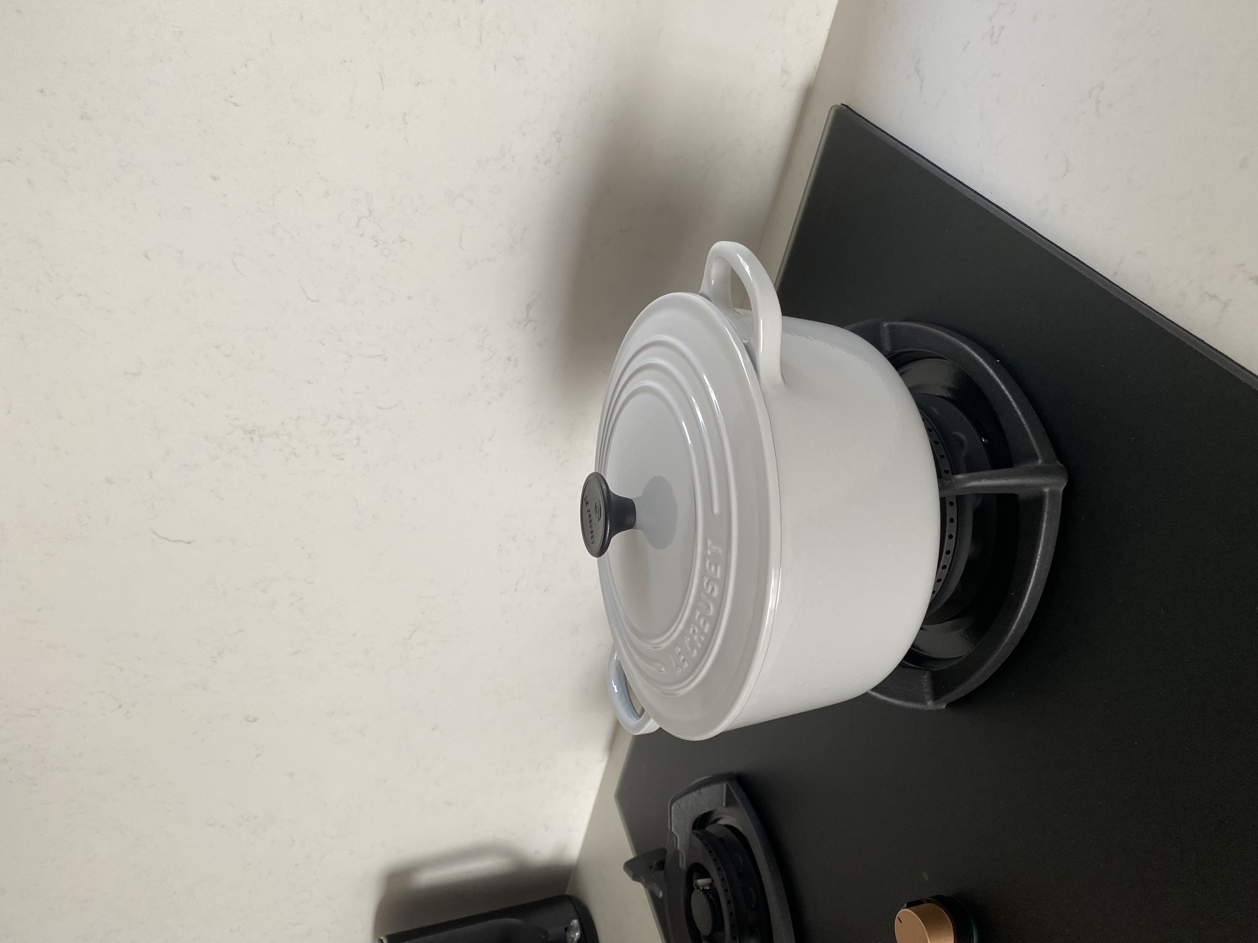 Aesthetic decorative, functional homewares at our place - White ceramic pot, black handle, black stove burner, black stove