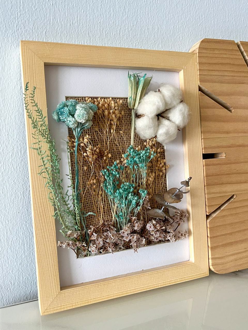 Create a unique home with customised artwork  - frame, botanical arrangement, woven background, natural elements, dried
