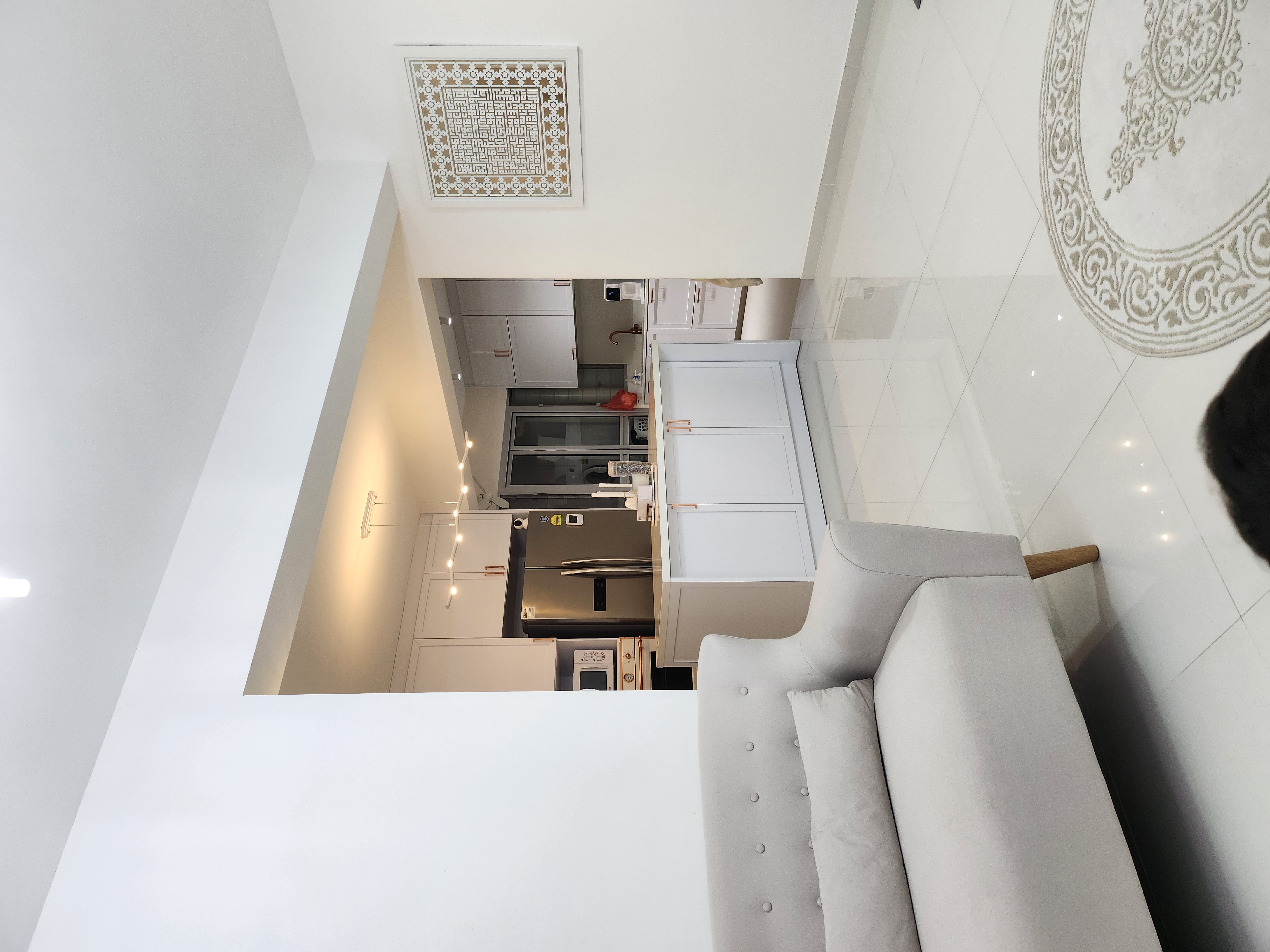 Lightings by punggoHField - Modern minimalist kitchen with sleek white cabinets, stainless steel appliances, and a large