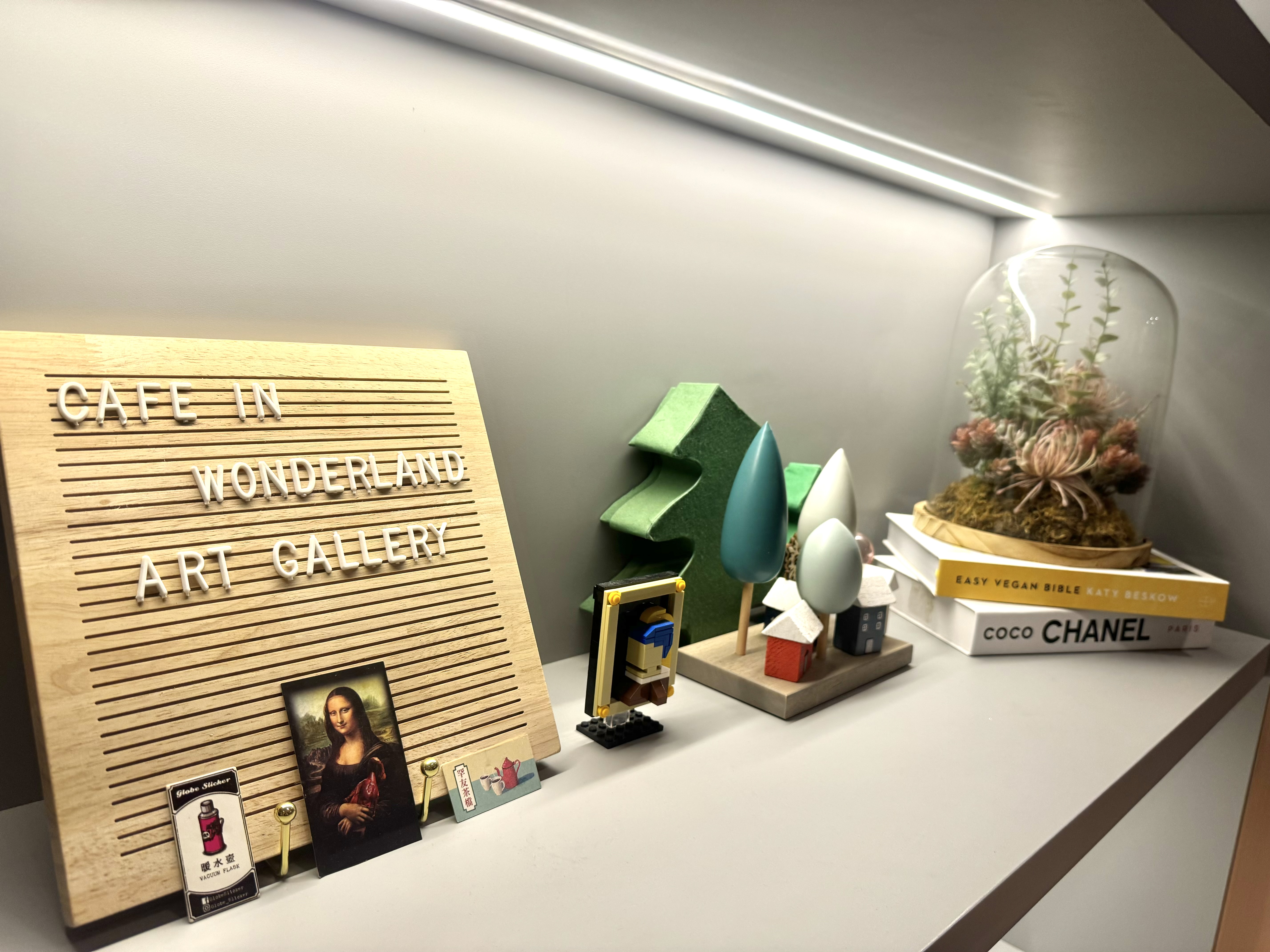 FAQ: Your Space = Your Vibes 🏠  - Wooden sign with "CAFE IN WONDERLAND ART GALLERY" text, small figurine of a person