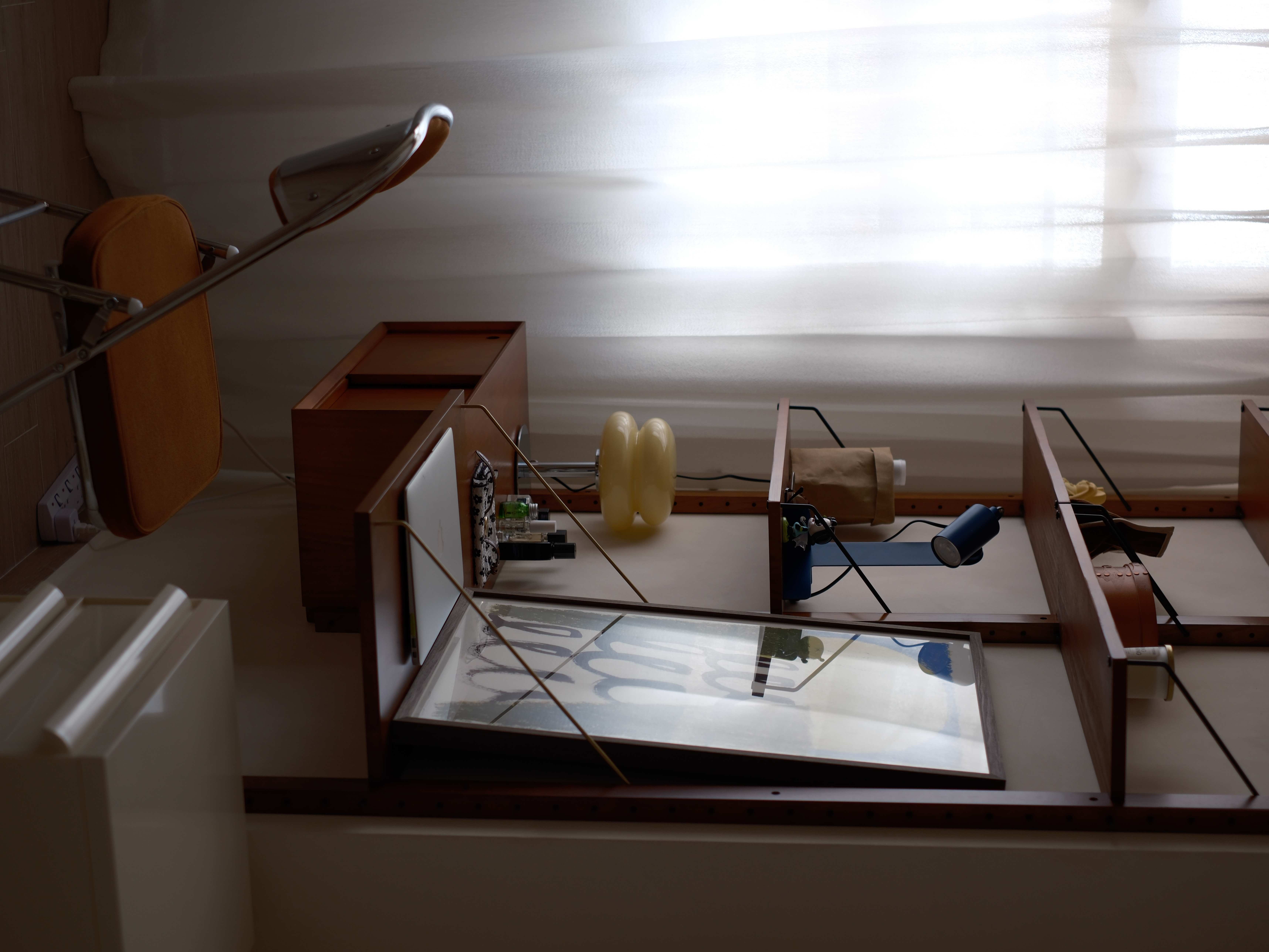 Blending Wardrobe and Study in One Space - wooden desk, yellow balloon, black and white patterned bag, brown paper bag, blue