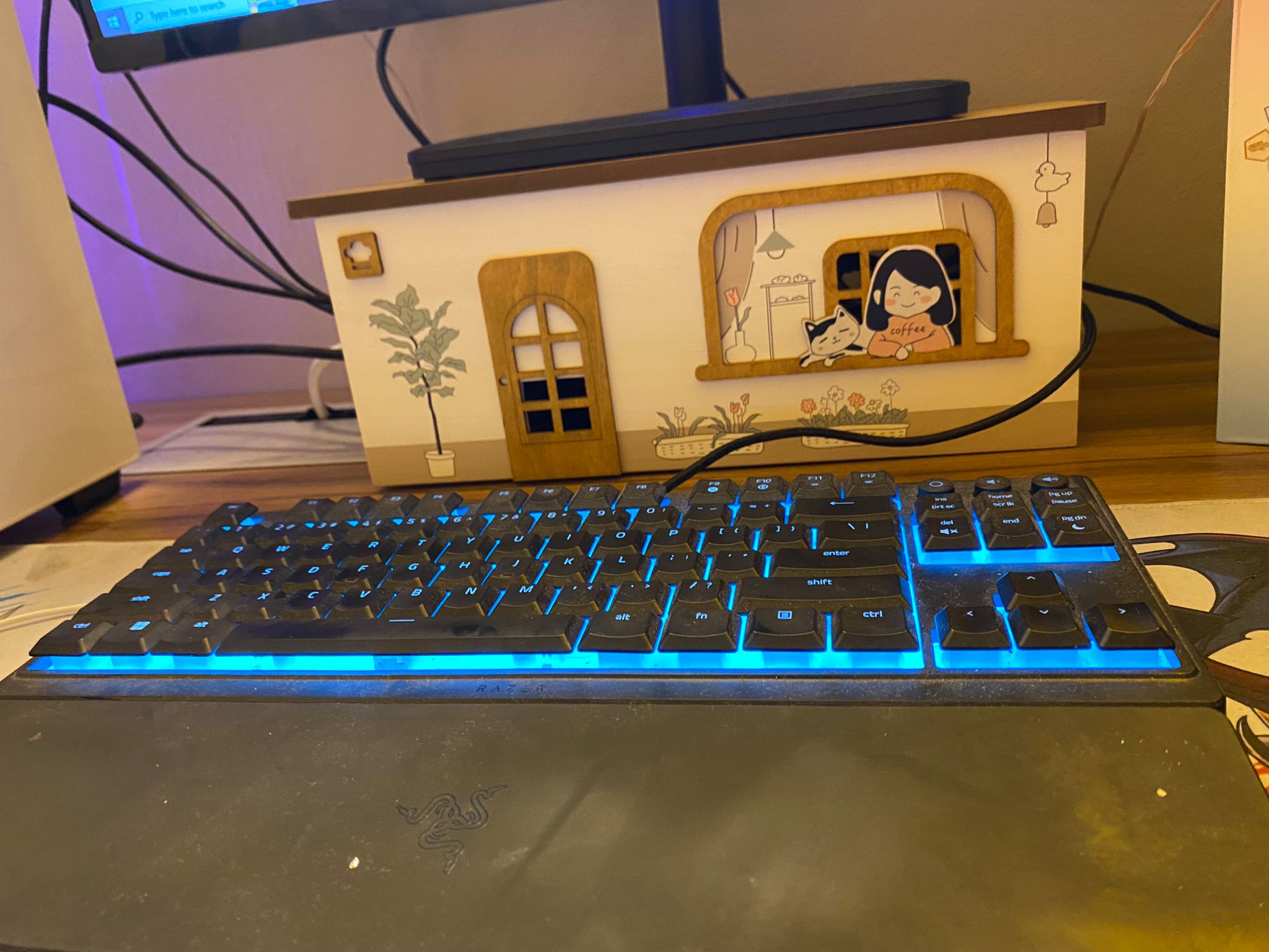 Our cozy gaming corner: with Lan shop vibes, said the man in his 30s - Sleek black gaming keyboard with blue backlighting