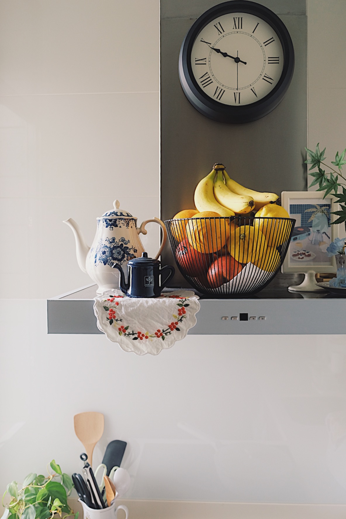 How we make a tiny condo kitchen functional and aesthetic - blue and white teapot, black teapot, fruit bowl, yellow bananas