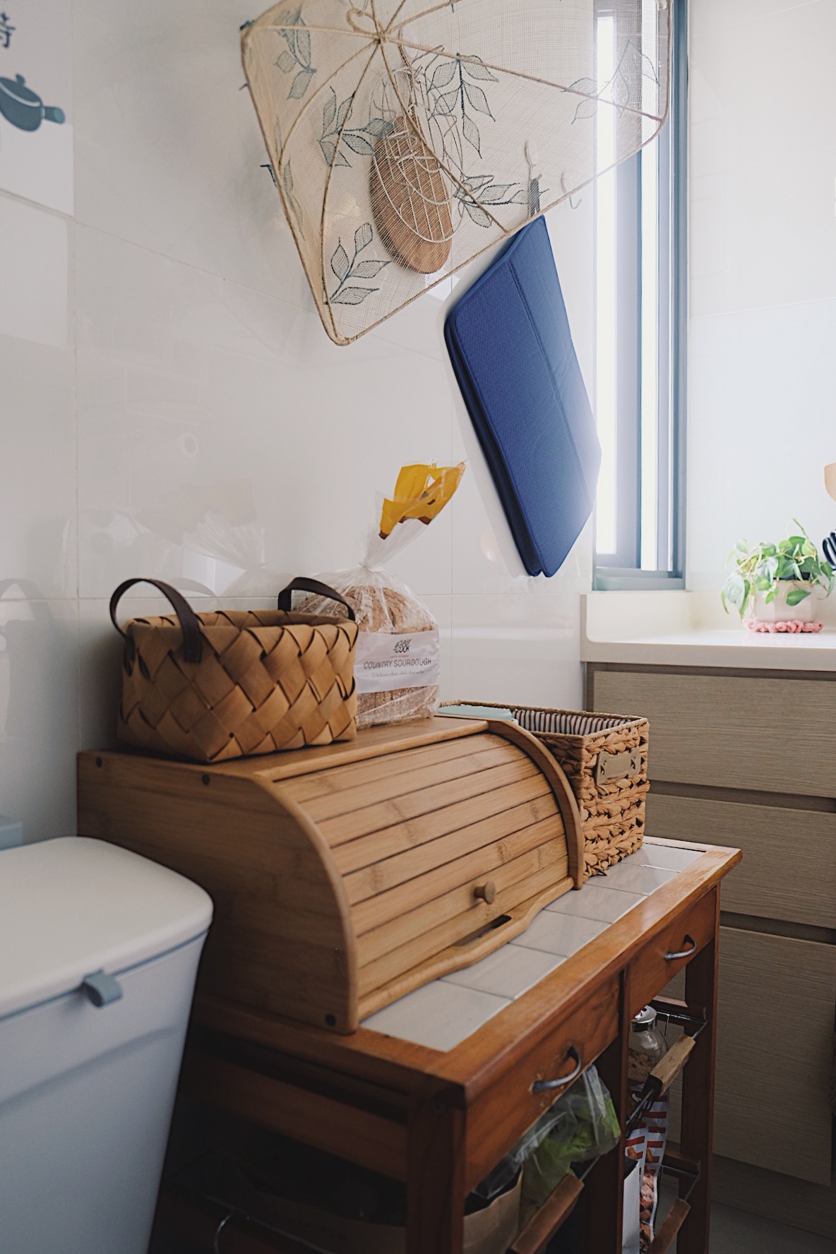 How we make a tiny condo kitchen functional and aesthetic - Toilet, basket, wooden table, kitchen, storage, natural light