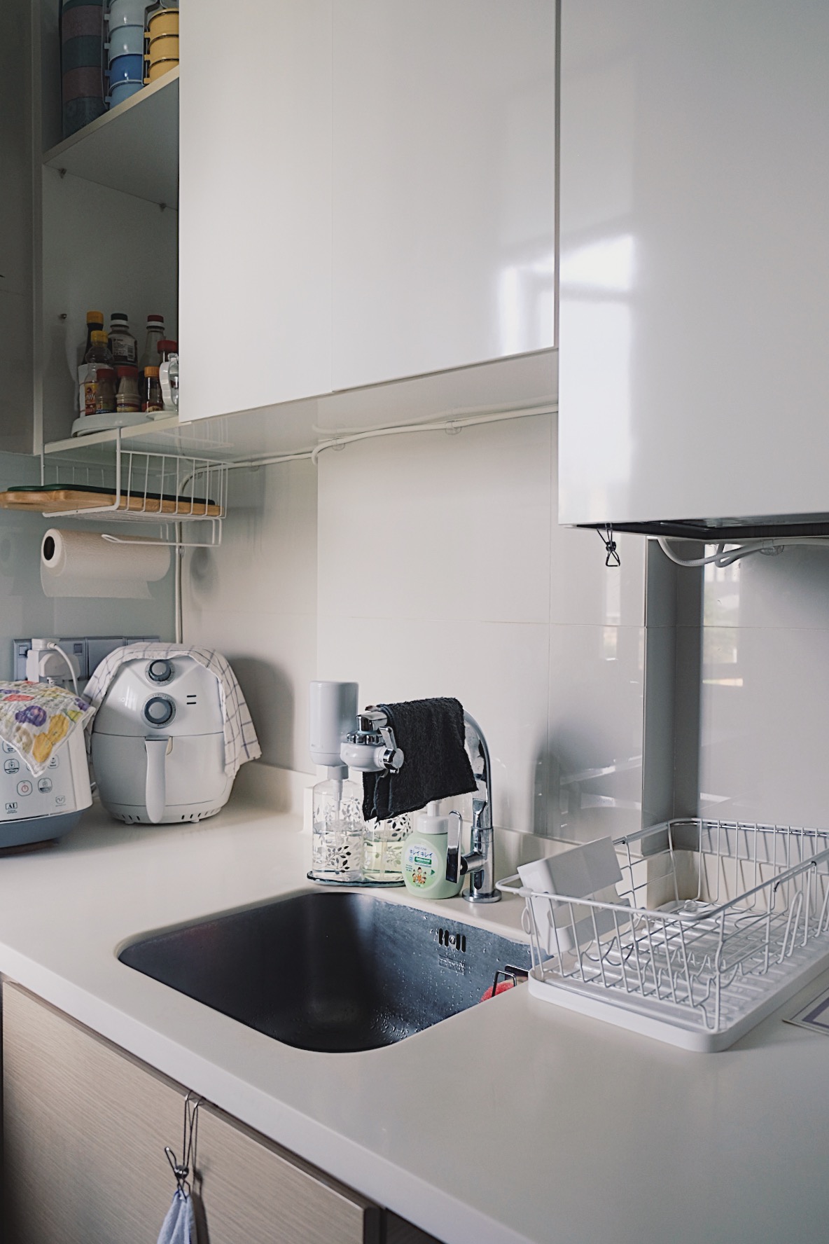 How we make a tiny condo kitchen functional and aesthetic - White kitchen countertop, modern appliances, white cabinets, open