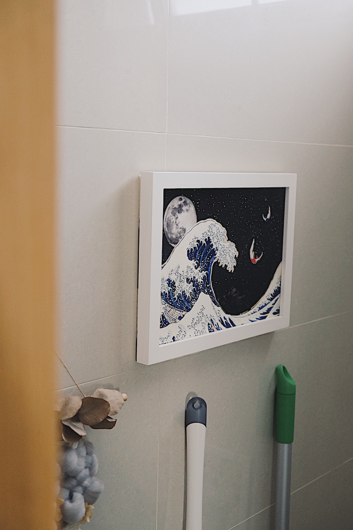 Styling our bathrooms with framed magazine cutouts - Japanese wave illustration framed, moon and stars in background