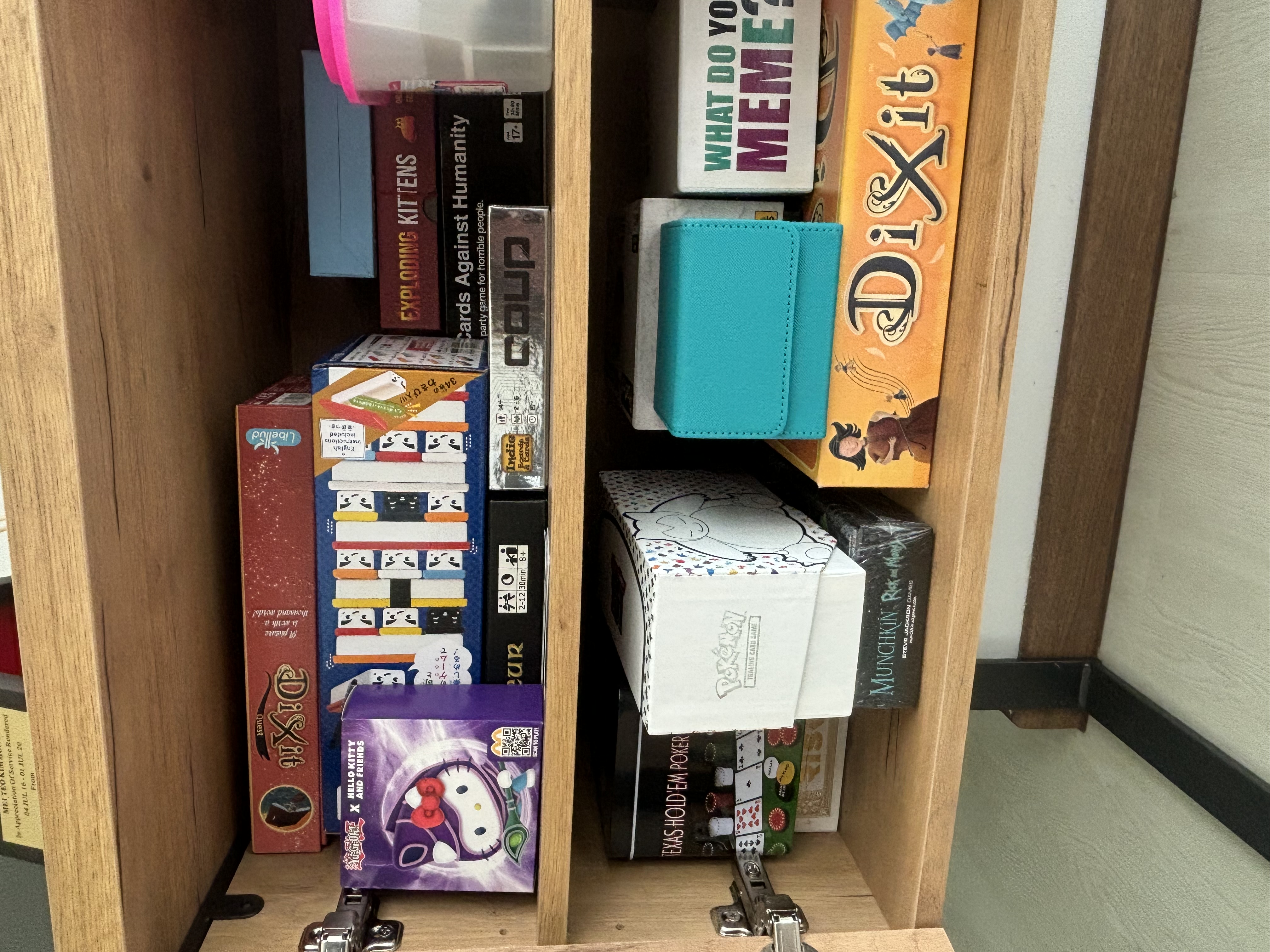 Our Living Room Sideboard Tour - Board games, puzzles, and board games, including "What Do You Memes?" and "Dixit, " are