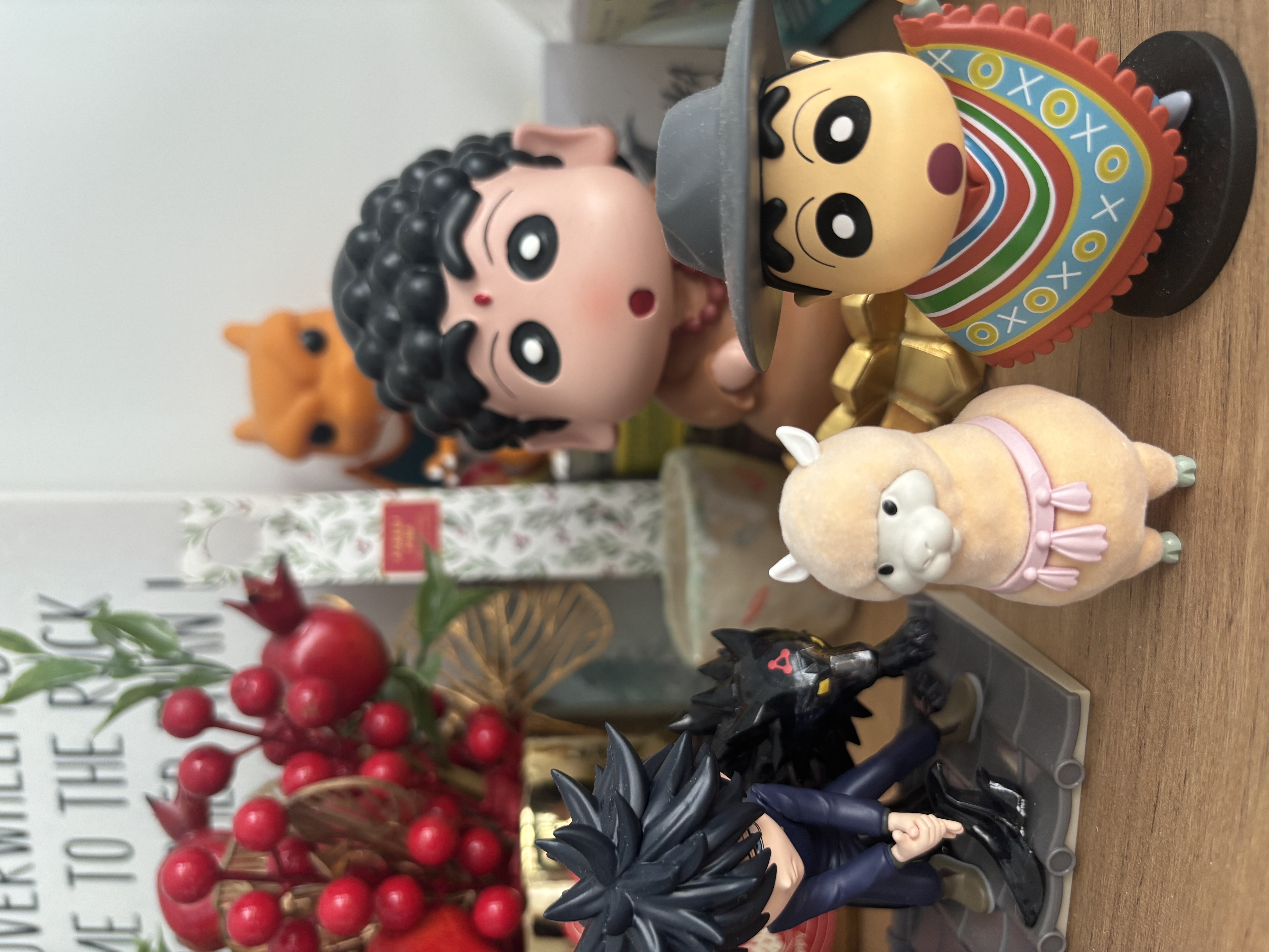 Our Living Room Sideboard Tour - Toy figurine with black curly hair and red nose, wearing a gray hat, holding a colorful