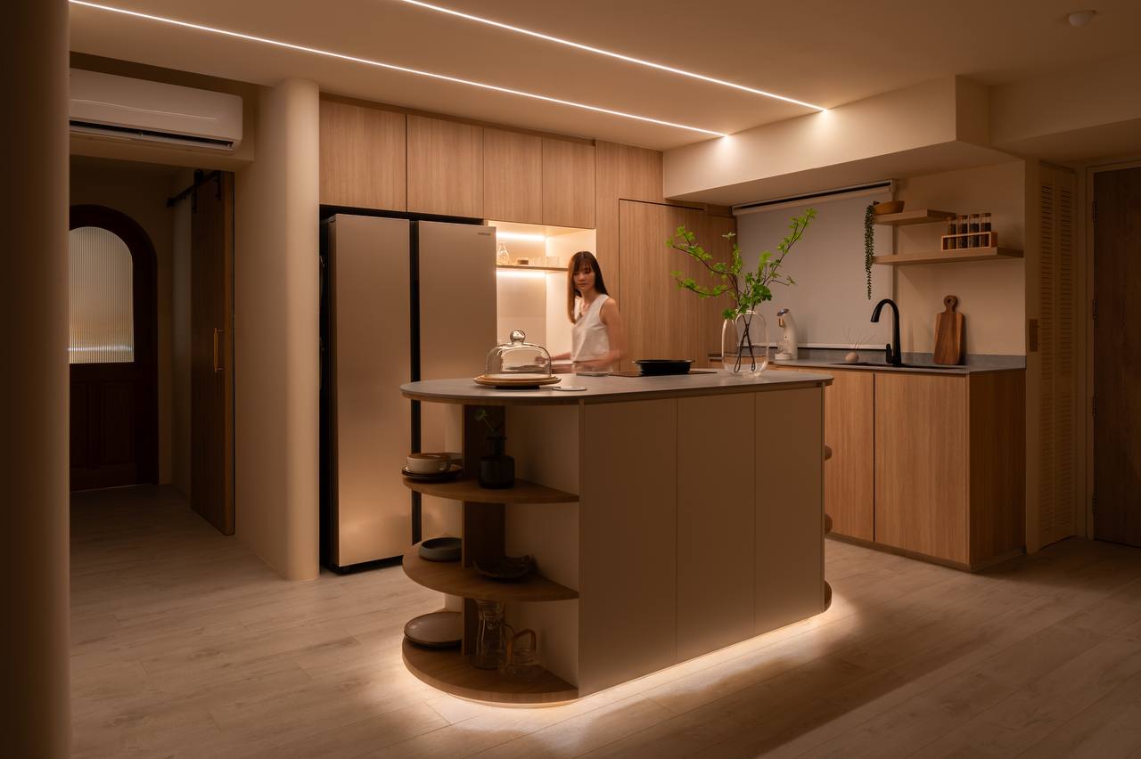 Home Sanctuary: Living Room - Modern kitchen with sleek design, warm lighting, wooden cabinets, island with built-in