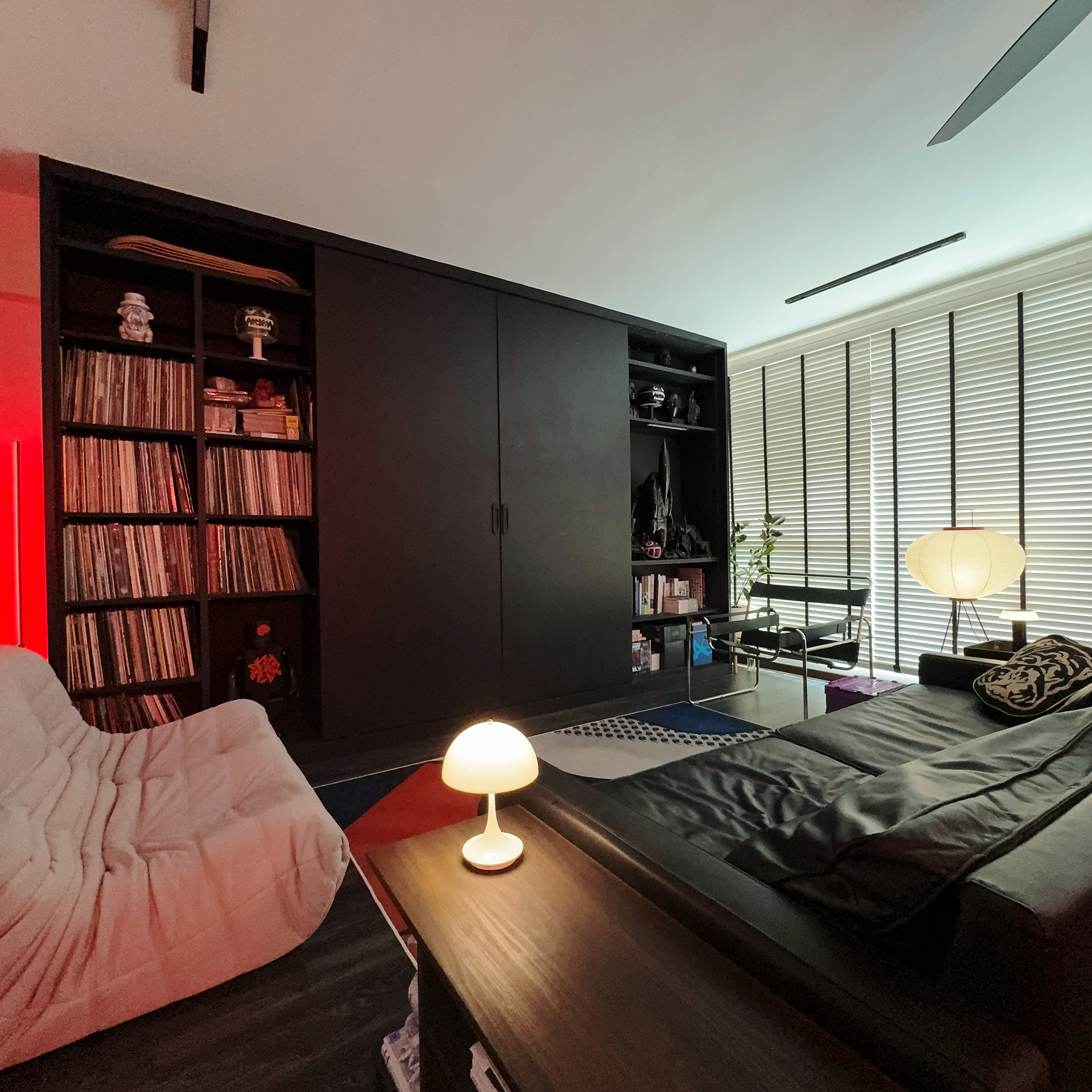 A Dark Mid-Century Modern Living Room That’s a Canvas of Creativity - Modern living room, cozy corner, large bookshelf, red