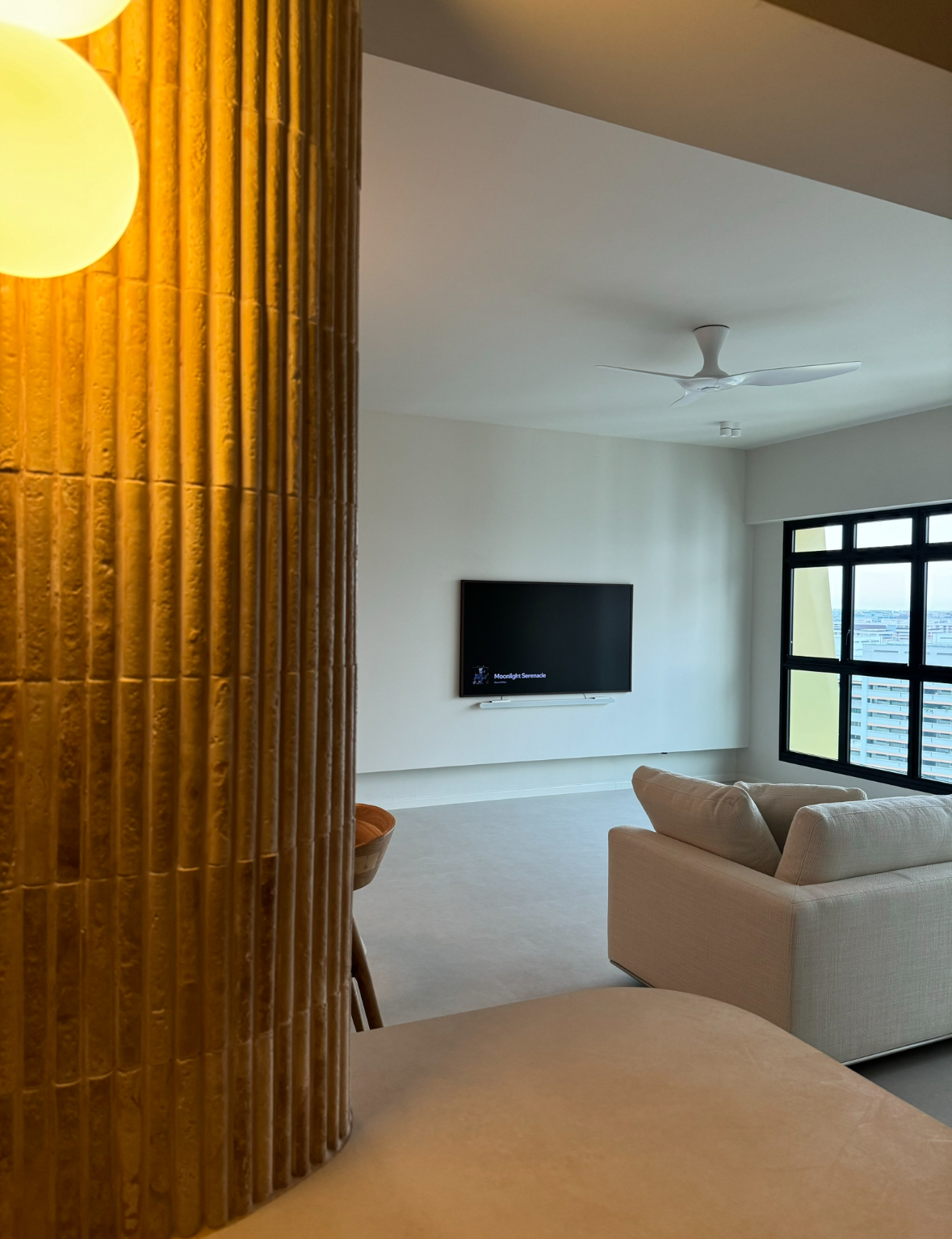 Welcome to our Edition Hotel inspired living room - Golden vertical columns, modern ceiling fan, minimalist living room