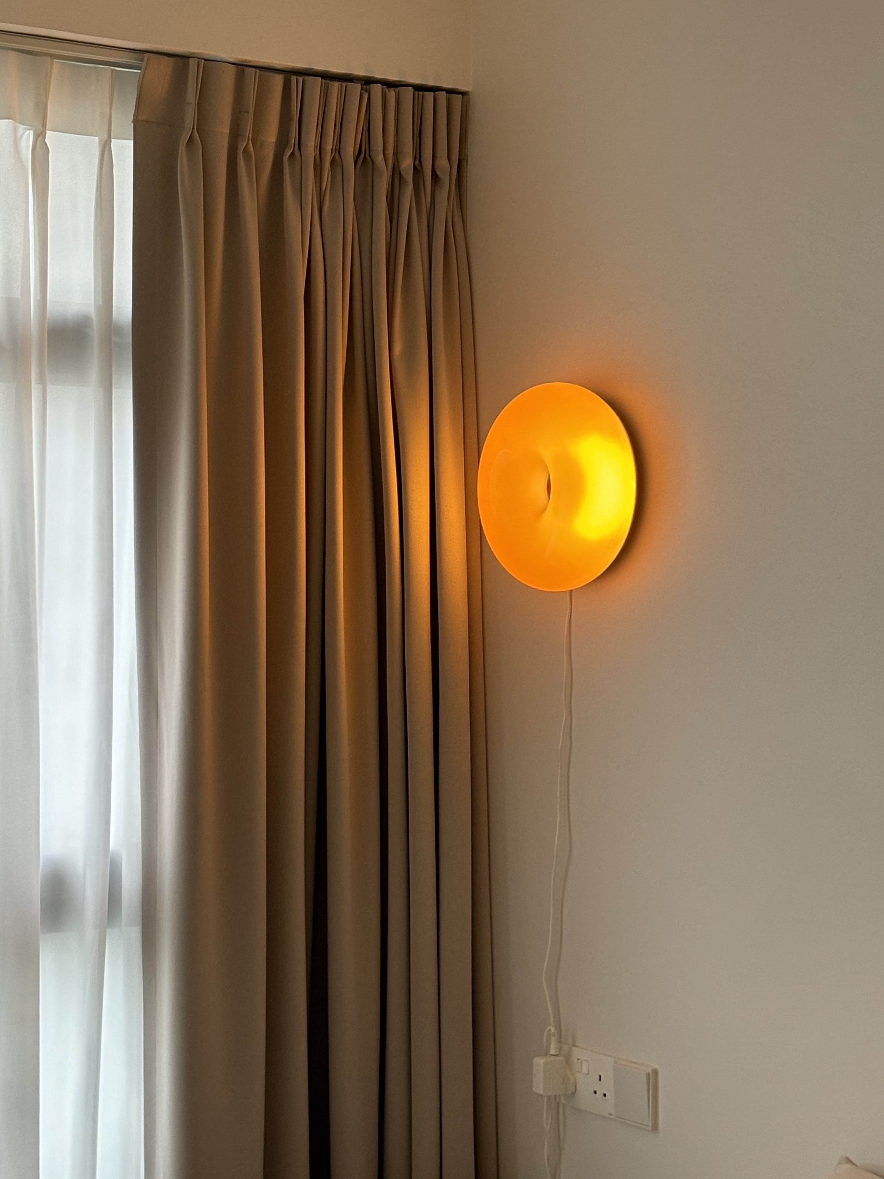 A Simple Mid-Century Modern 4-Rm BTO under $60k - Soft beige curtains, warm glow from wall sconce, minimalist decor, cozy