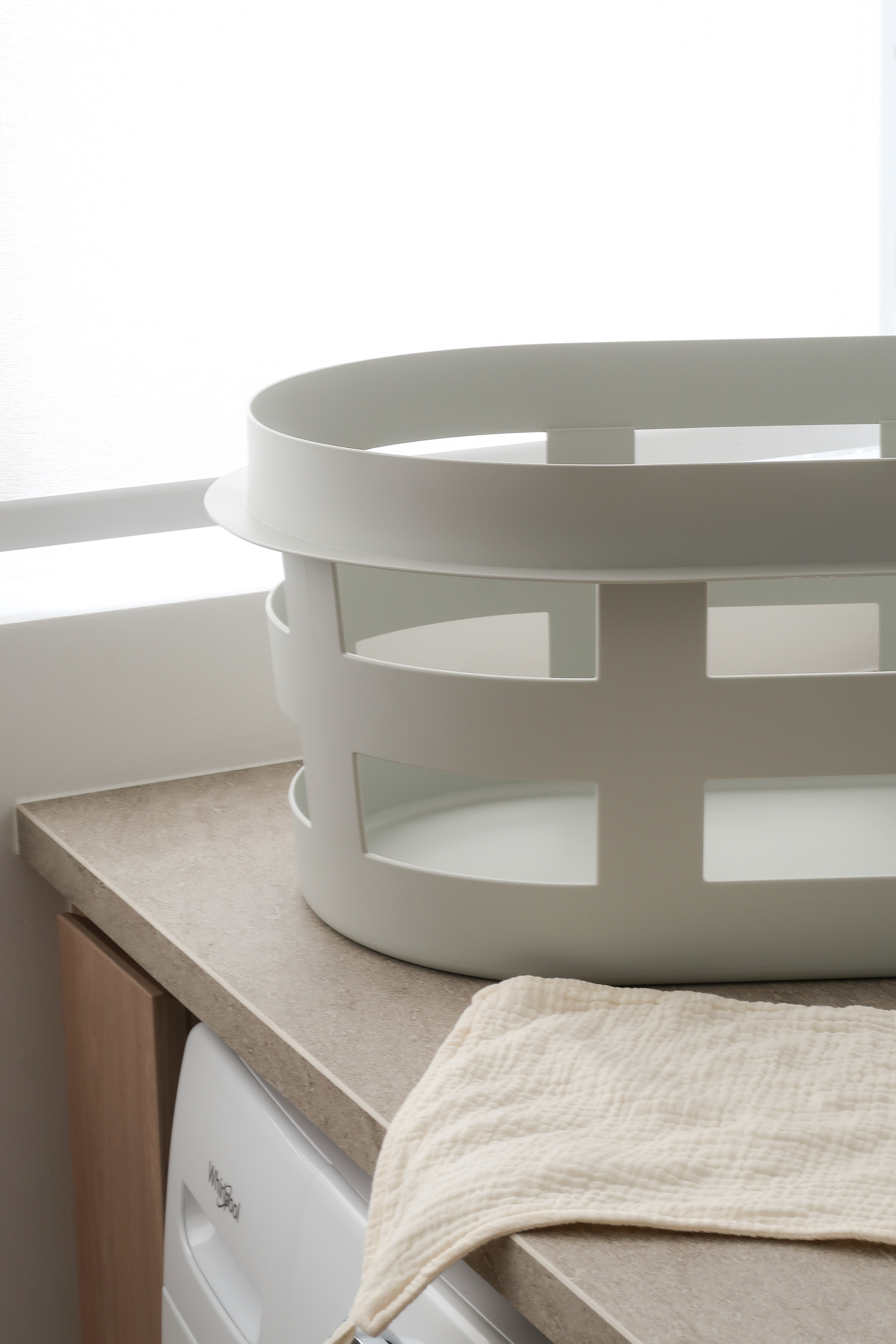 Service Yard: Making the Most of Small Spaces - White circular laundry basket, minimalist design, floating shelves, modern