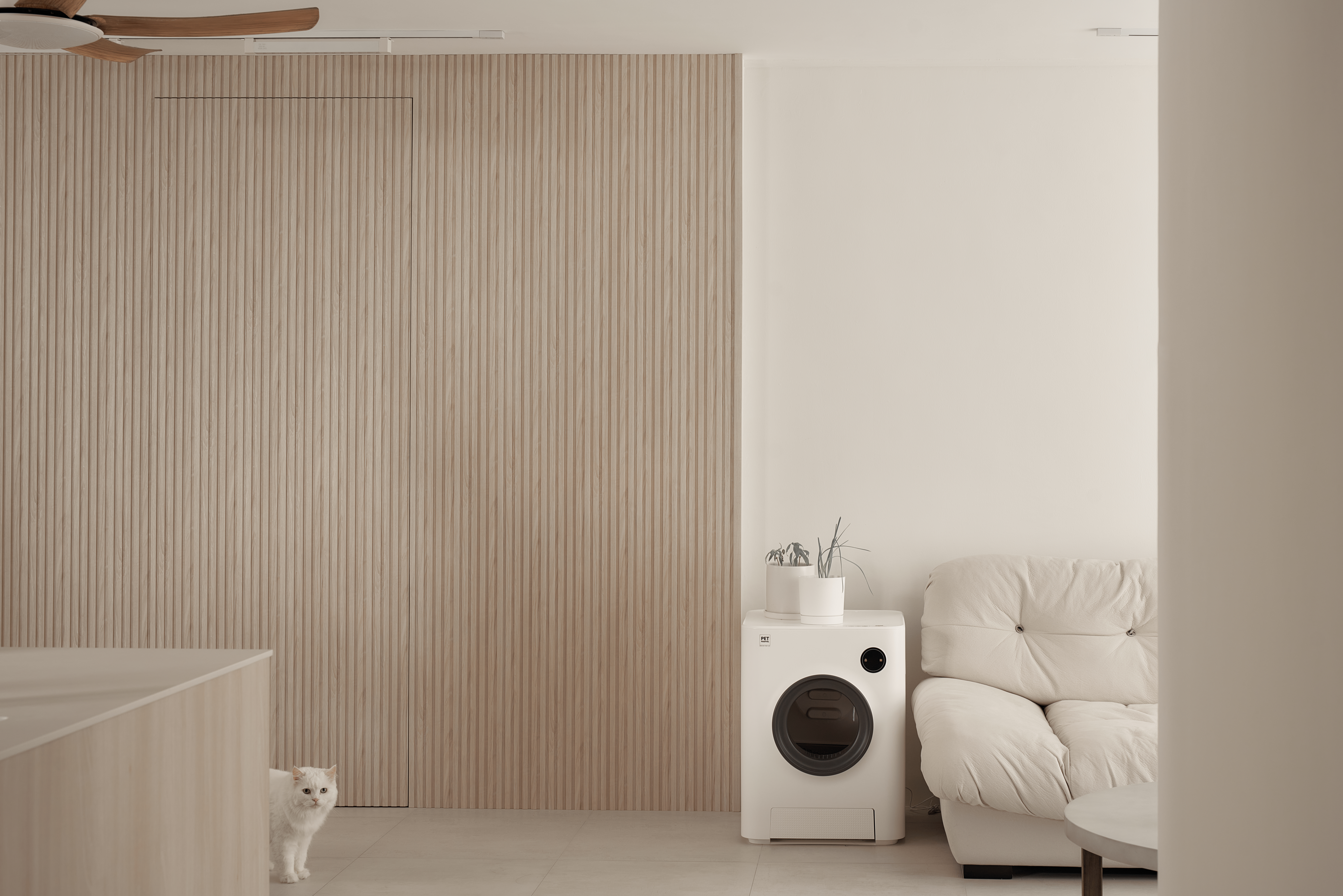 A Scandinavian-Inspired Haven of Modern Elegance - Wooden panel wall, minimalist design, white ceiling fan, light beige