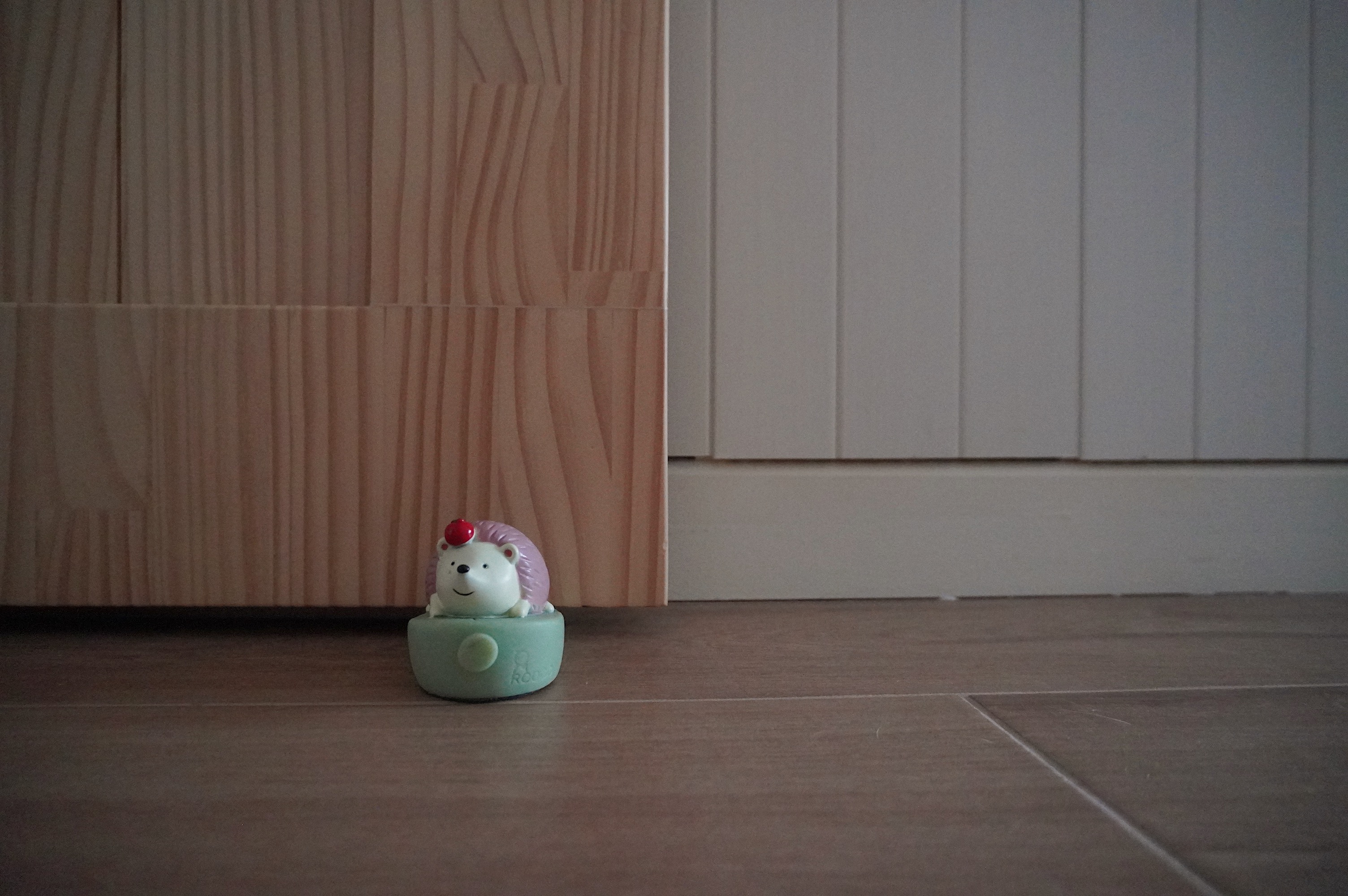 From Barn Door to Panels: Inside Our Modern Farmhouse Living Room - Small, cute, white hedgehog figurine with pink accents