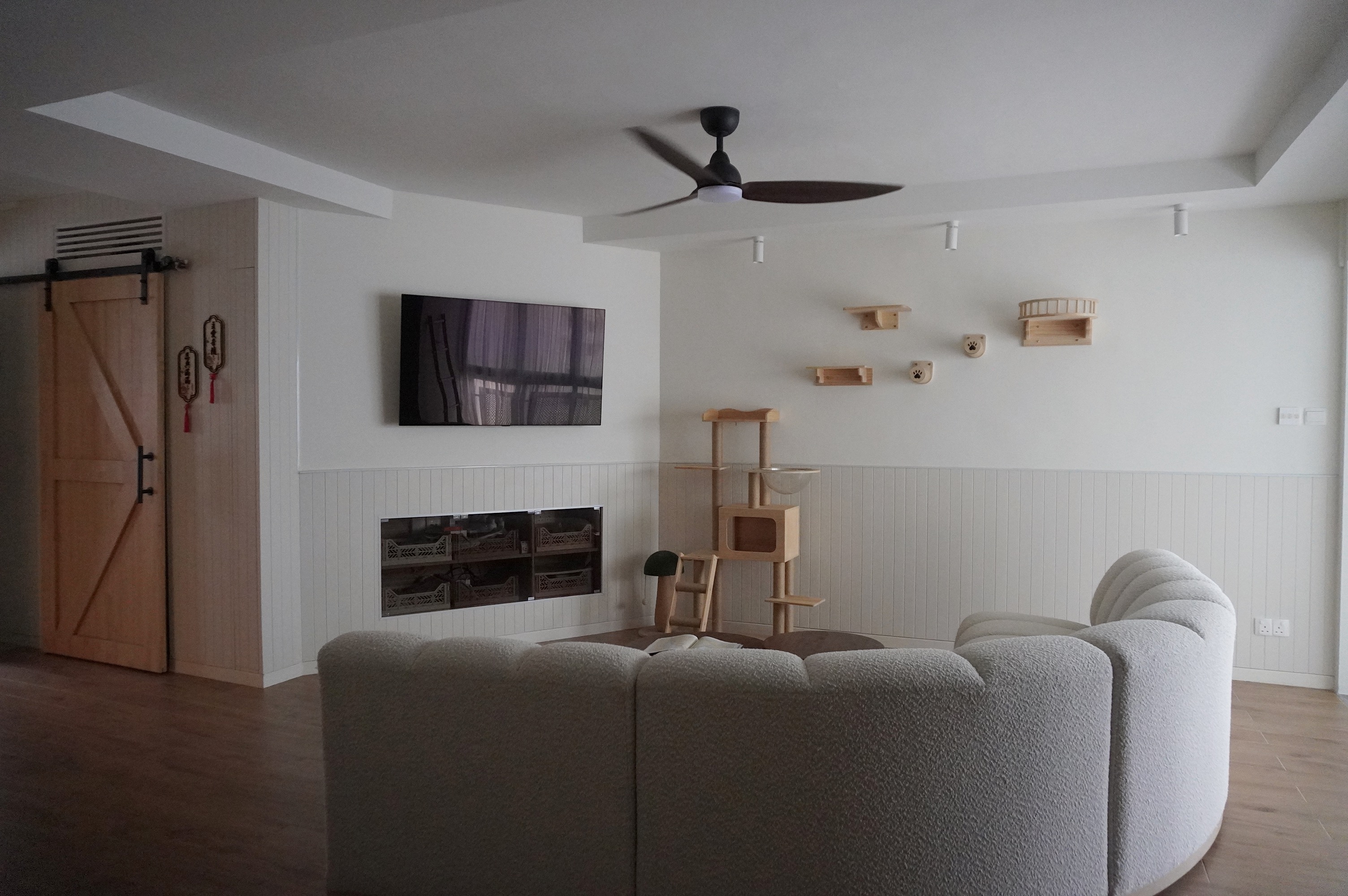 From Barn Door to Panels: Inside Our Modern Farmhouse Living Room - Wooden door, light-colored walls, ceiling fan, modern