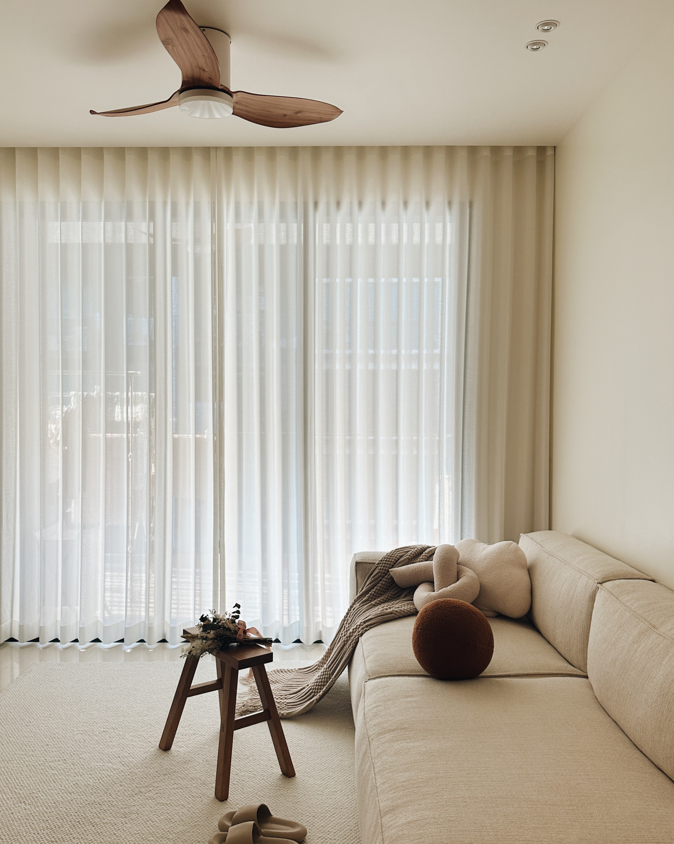 ⁠Modern Minimalist: A Peek into My Living Room - Soft, neutral-toned living room, cozy sofa, beige and brown cushions, plush