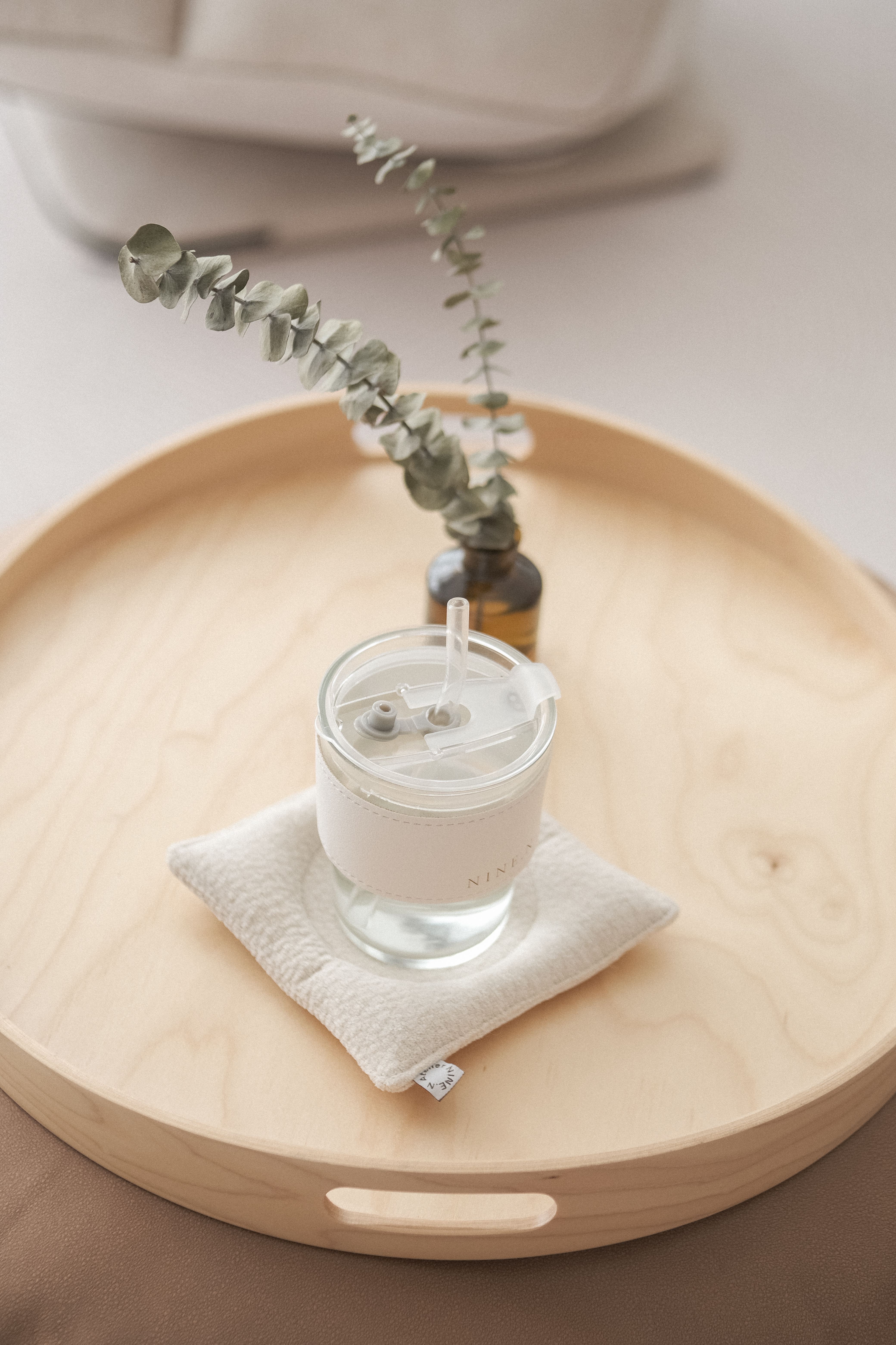 No Built-Ins, Just Space: A Cosy 'White' Living Room  - glass of water on wooden tray, small plant in vase, natural light in