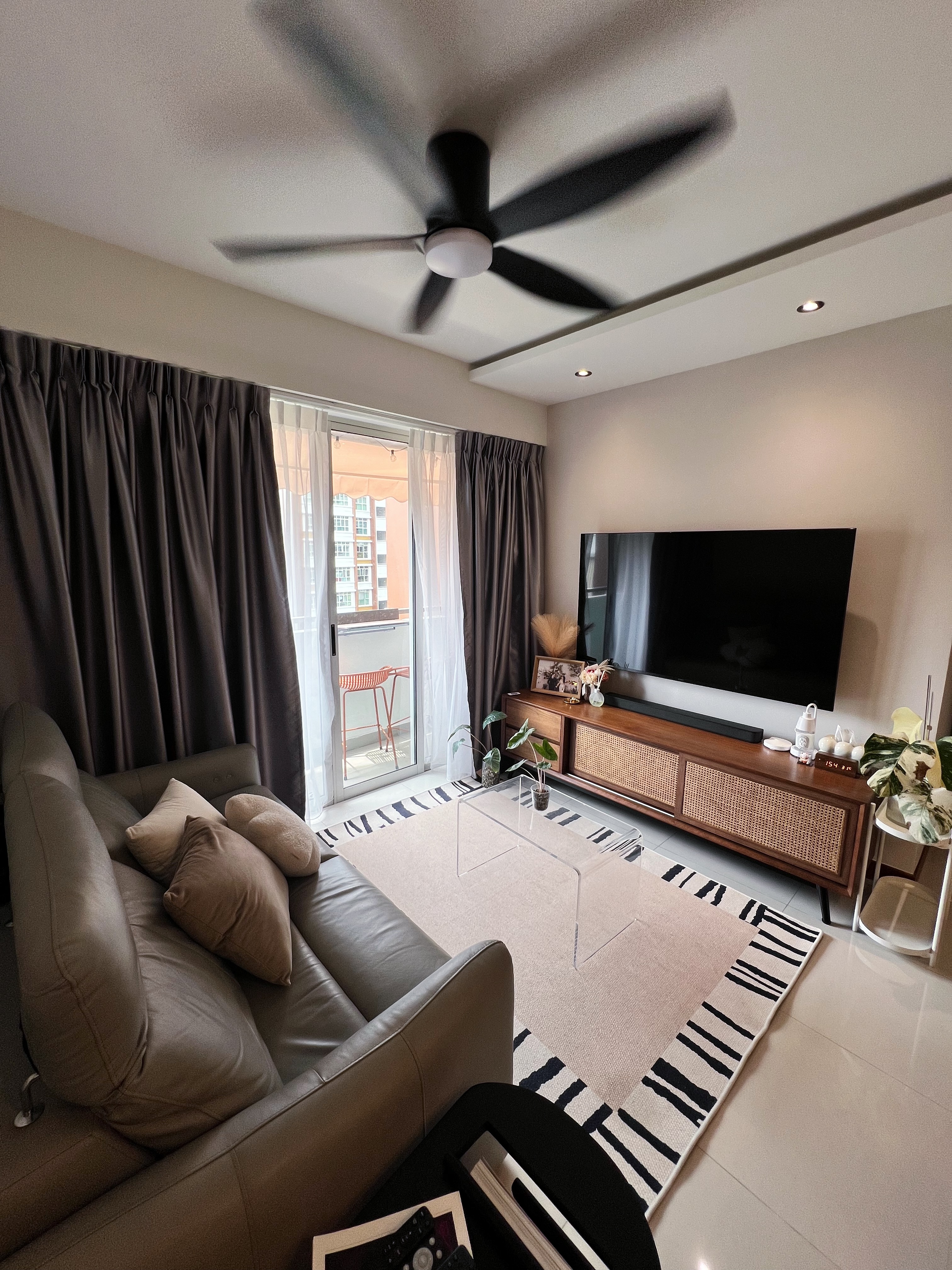 Moody Scandi Retreat — Minimal Built-ins and a Cozy Balcony - Modern living room with sleek design, large flat-screen TV