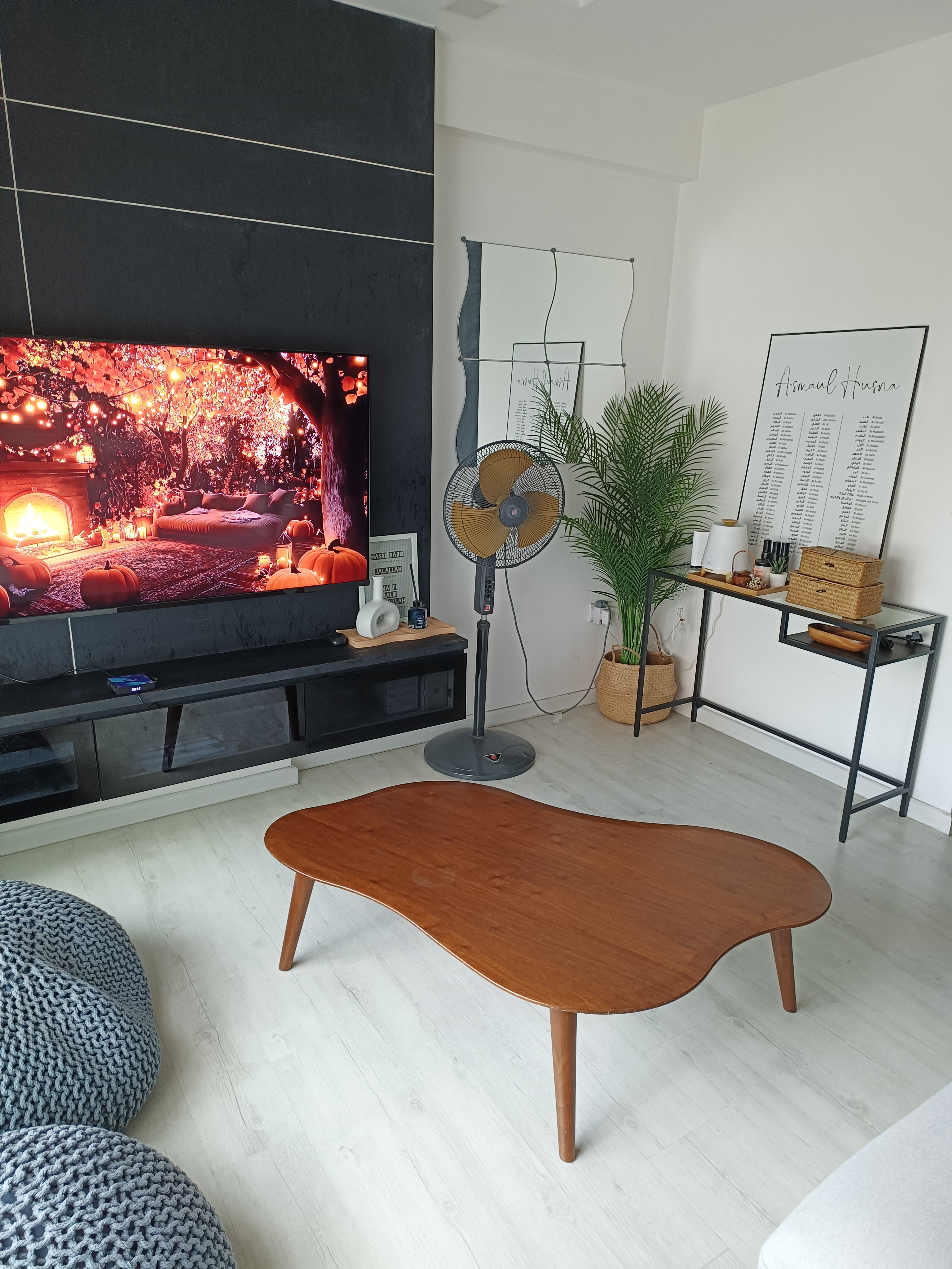 Sanctuary Space - Modern living room, cozy ambiance, autumn theme, warm lighting, large TV screen, cozy seating, wooden