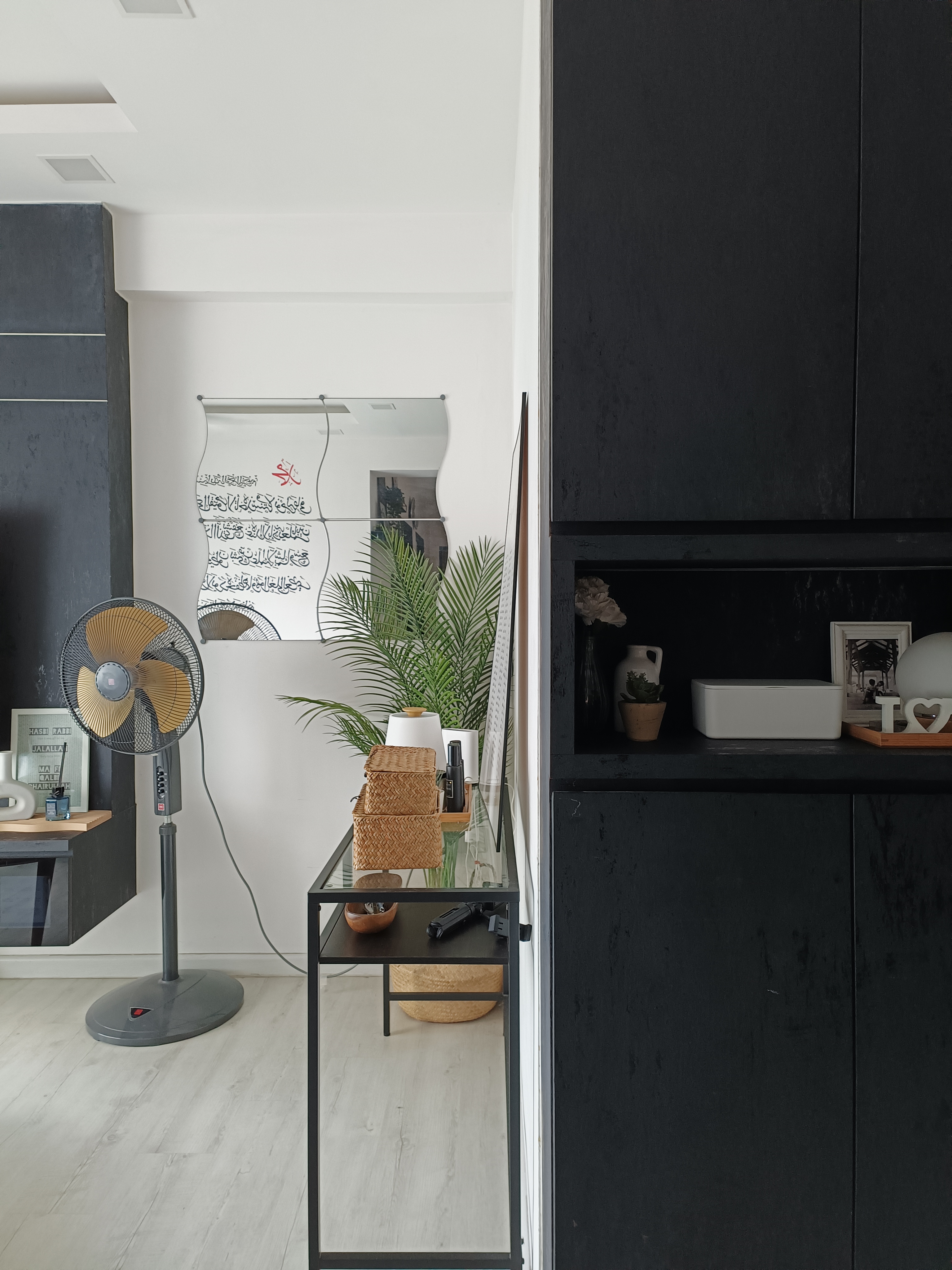 Sanctuary Space - modern minimalist interior, contemporary decor, sleek black cabinets, white wall, large fan, indoor plant