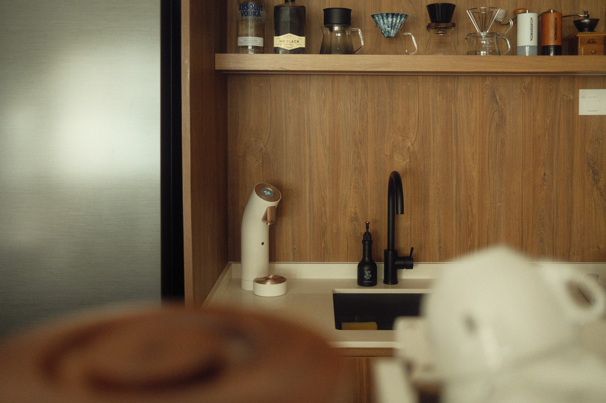 Inside a Coffee Content Creator's Home Cafe : Living Room Edition - Wooden kitchen shelf, coffee maker, black faucet, white