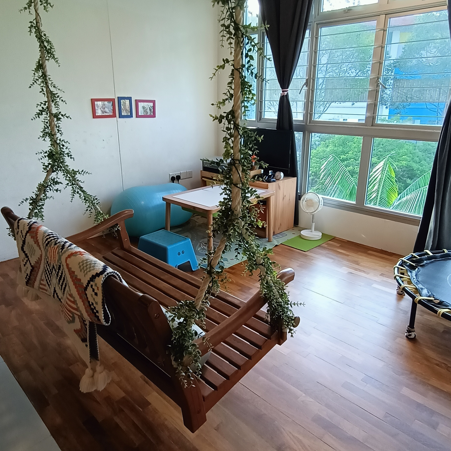 Serenity Oasis: Garden Theme Living Room (Complete with a swing) - Wooden rocking chair, green ivy, cozy room, natural light