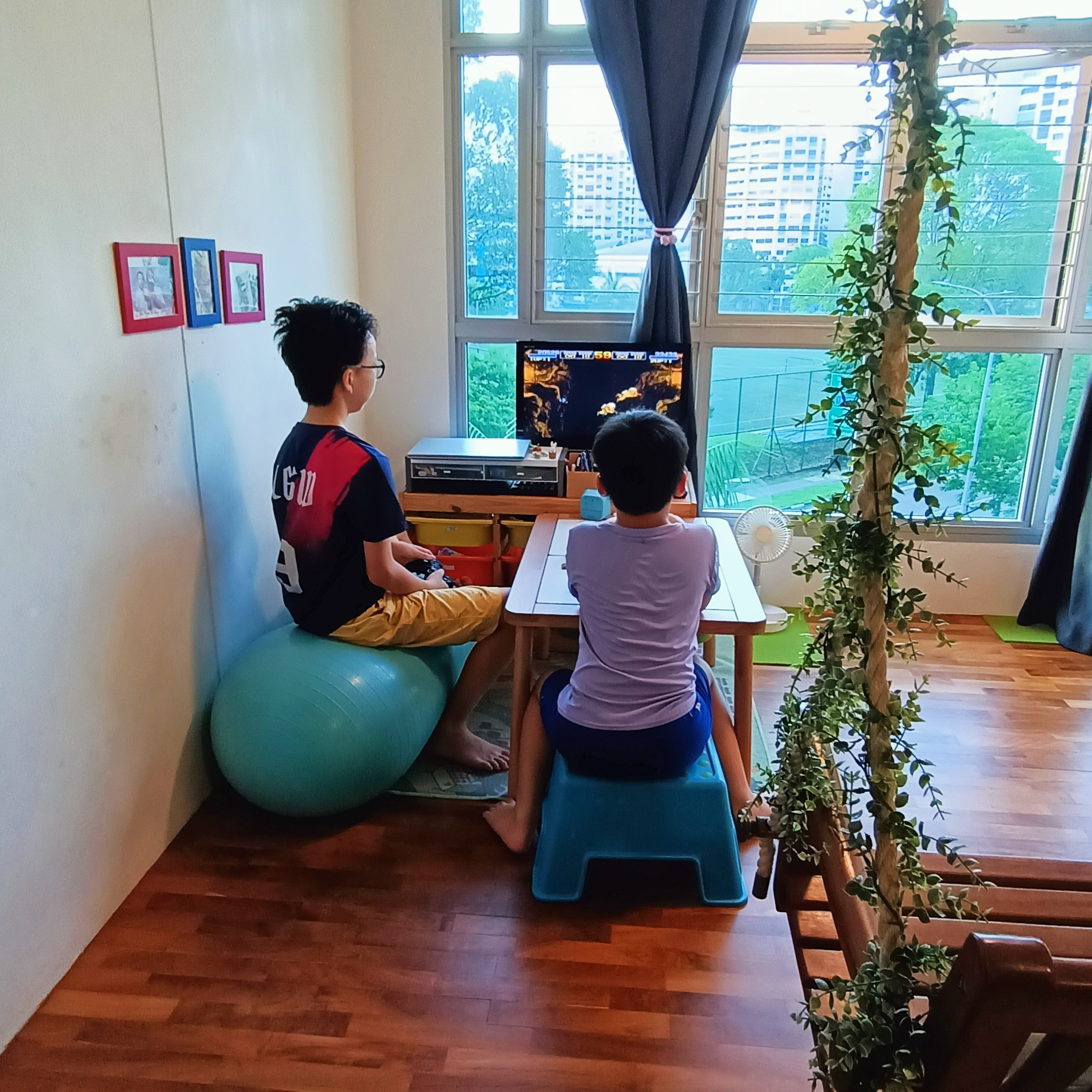 Serenity Oasis: Garden Theme Living Room (Complete with a swing) - Two children playing video game in a cozy room, Indoor