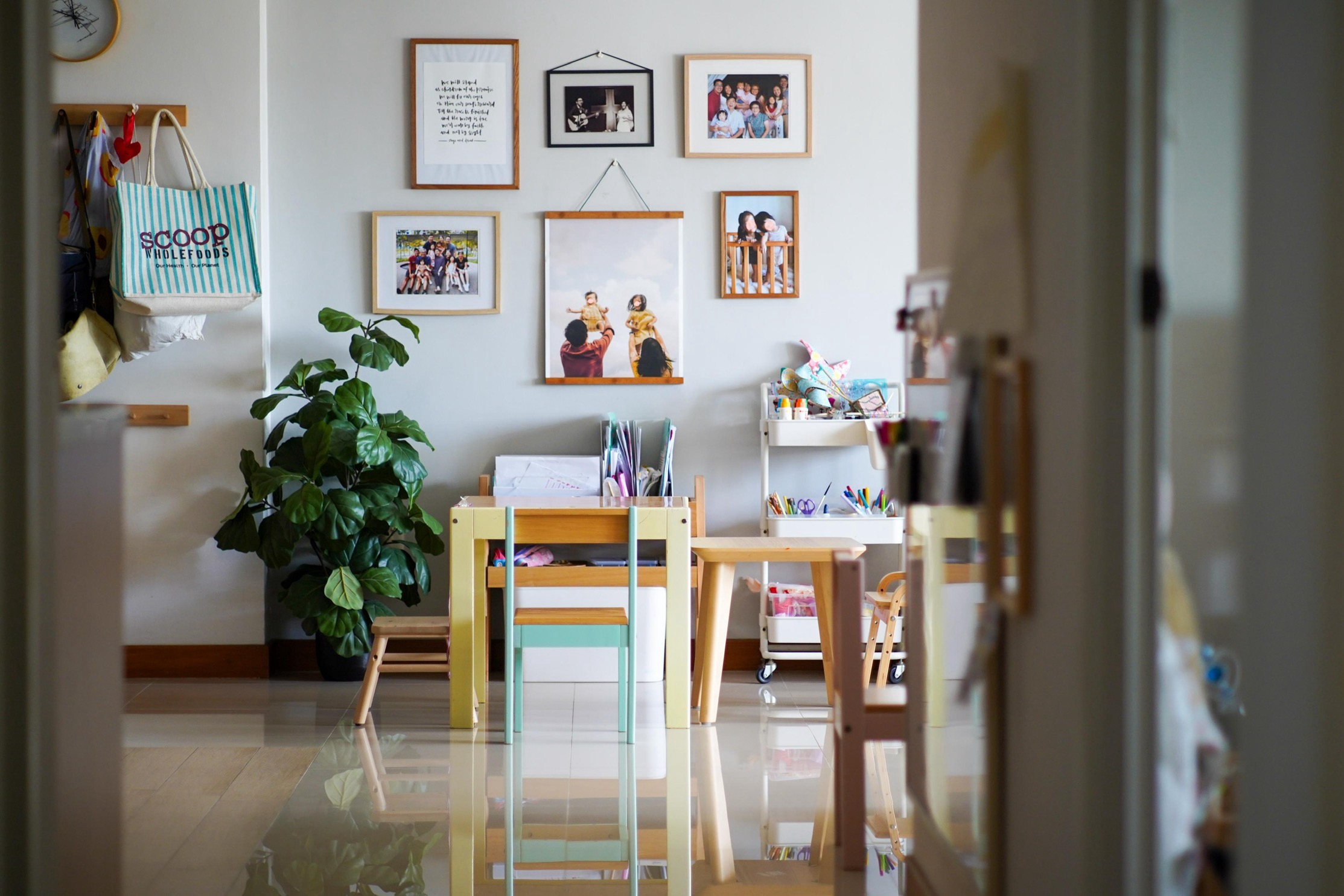 Creating a Cozy Home: Harmonizing Spaces for Both Kids and Adults - Wall with framed family photos, wooden desk with