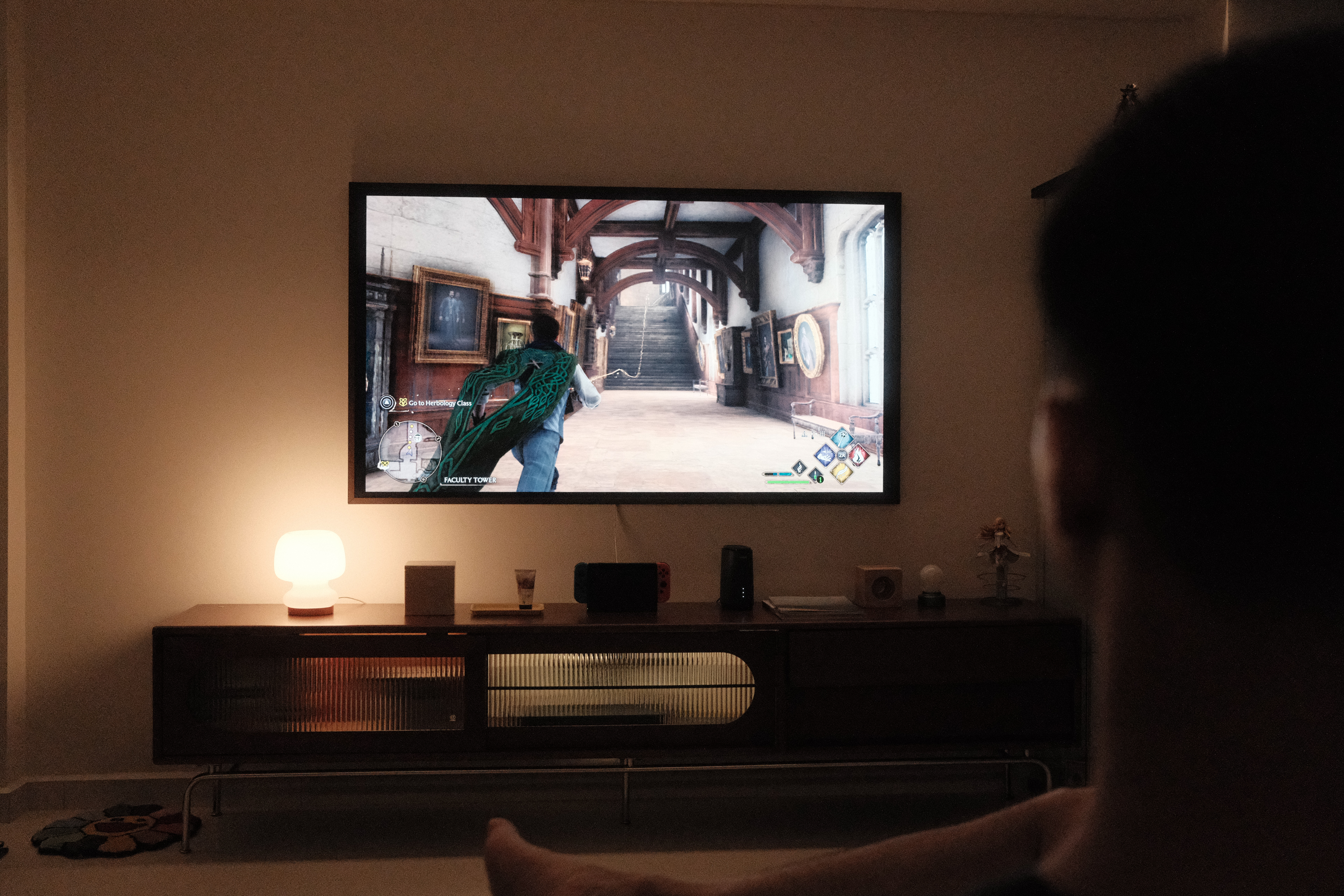 Bringing Timeless Charm into our Mid-Century Modern Living Room - Person watching video game on large TV screen, Game being