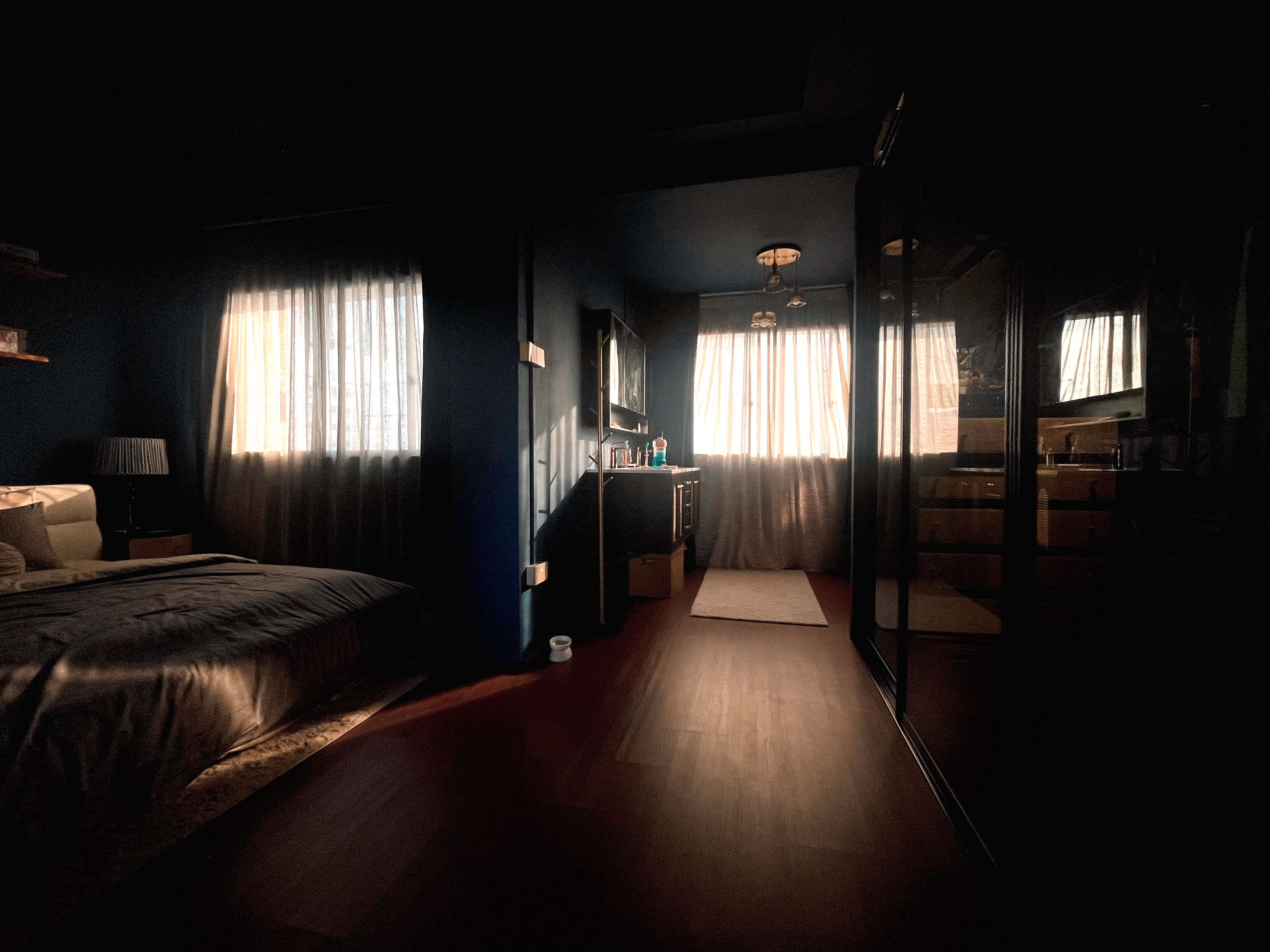 The Walk-In Wardrobe that Wasn't Planned - dimly lit bedroom, cozy atmosphere, soft lighting, natural light, bedside lamp