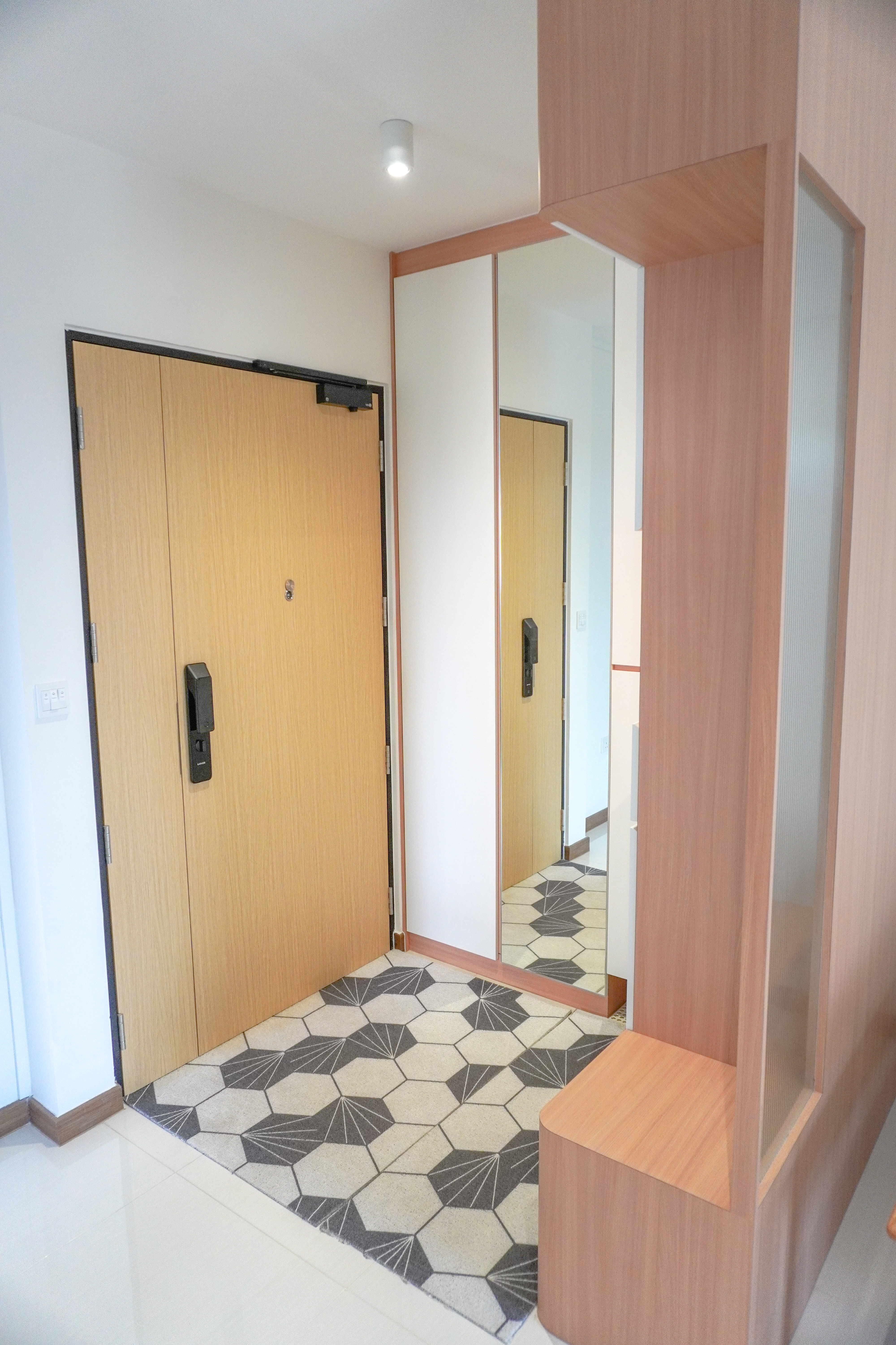 Our Entryway: The Transformation of Our 4-Room BTO - Wooden door, mirrored closet, geometric patterned floor, light-colored
