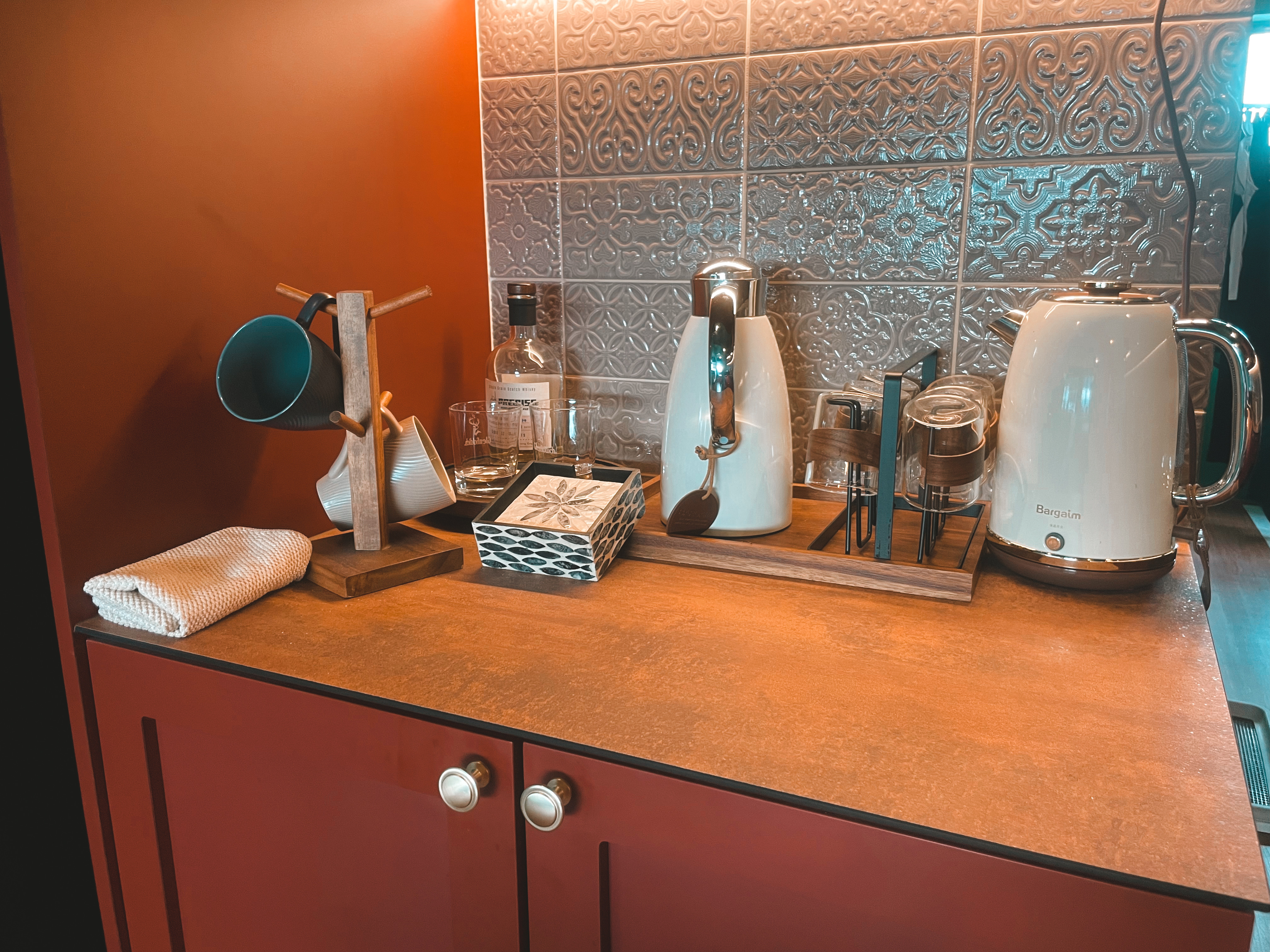 Kitchen Organization: The Ongoing Journey - Ceramic mug, wooden stand, white kettle, glass, tea set, decorative items, wooden