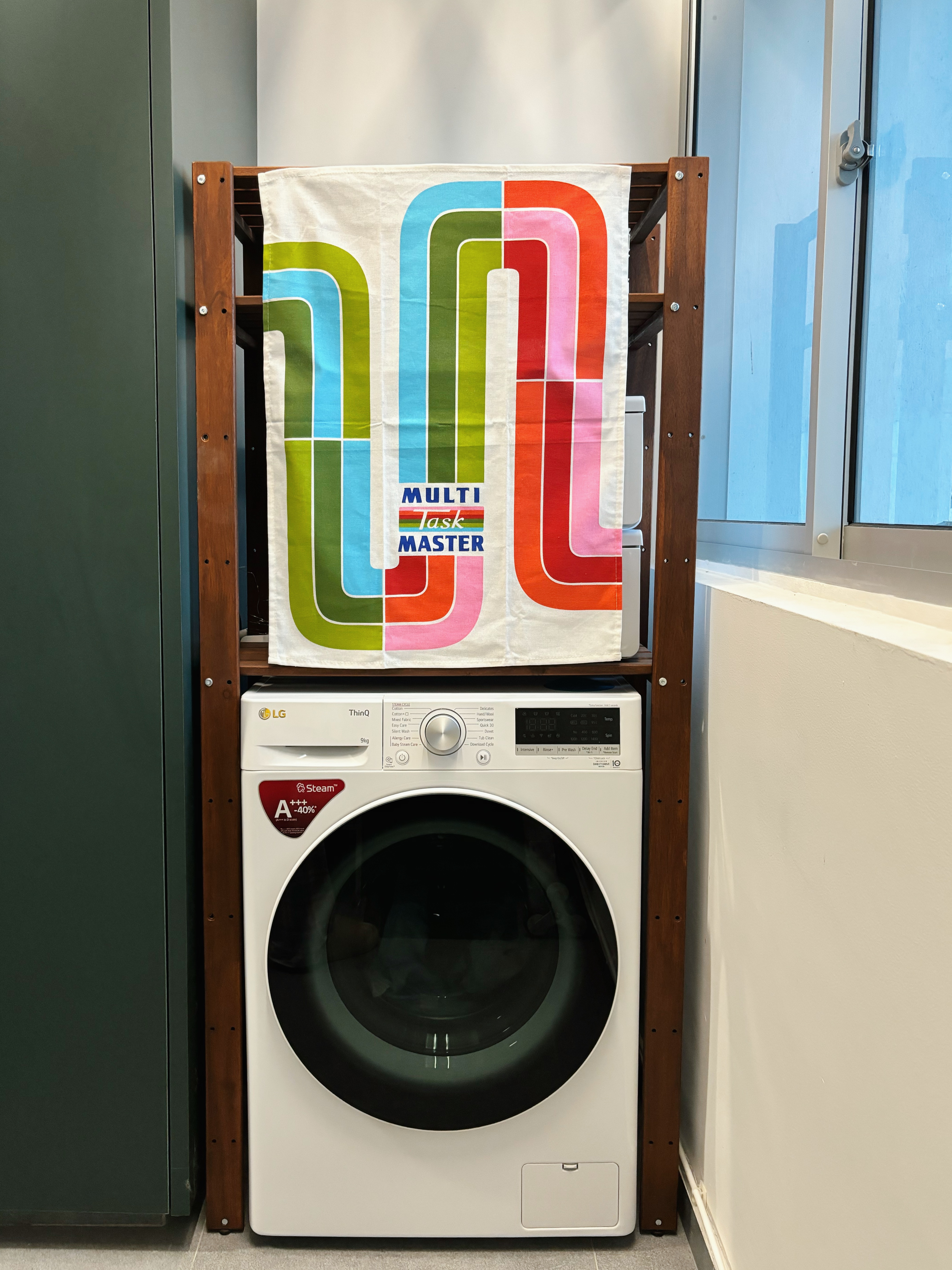 How We Made Our Service Space Work for Us - Colorful striped towel, multi-tasking master, modern laundry setup, white LG