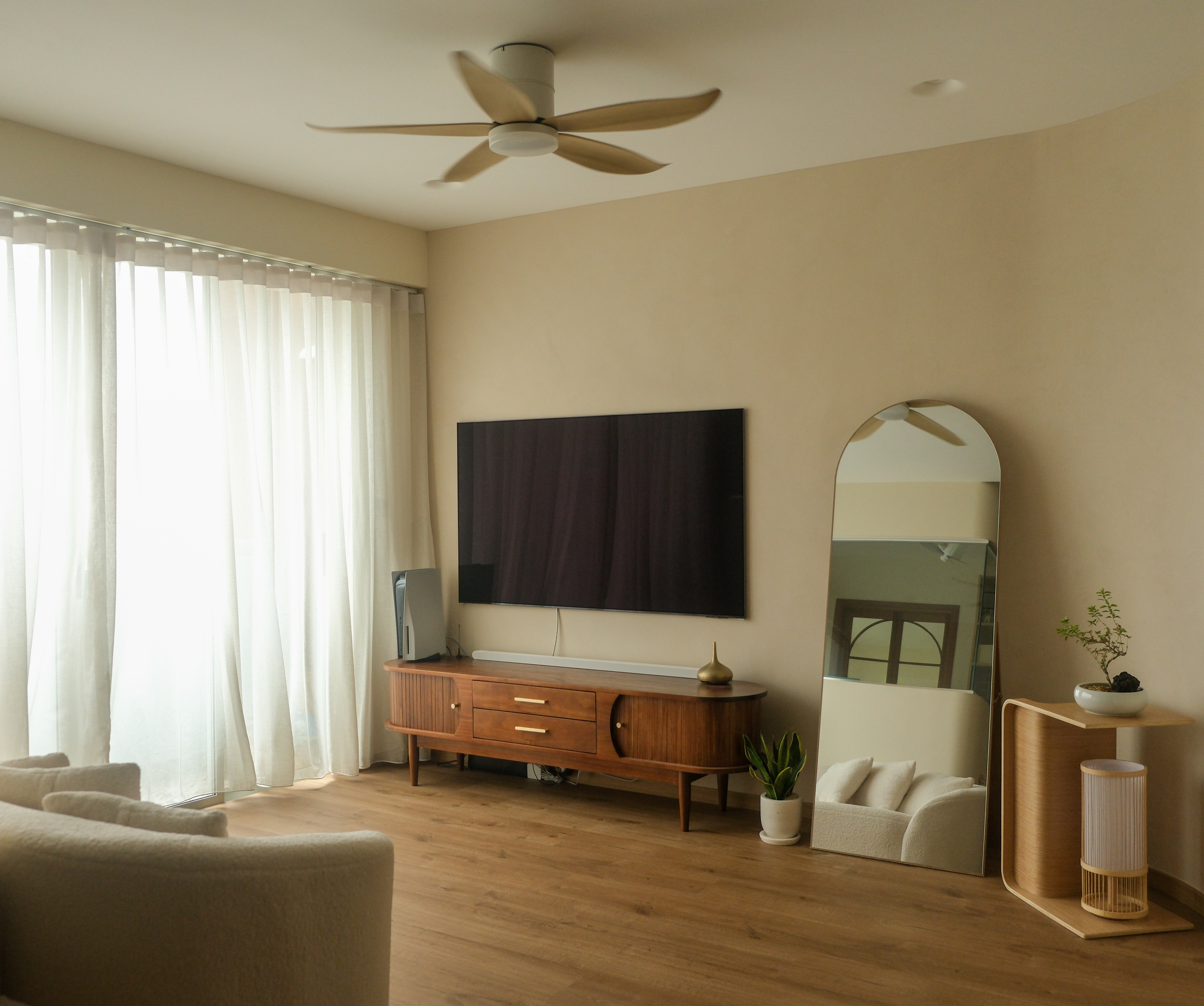 Minimalist Japandi Elegance. Warm tones and natural light.  - Large modern living room with beige walls, wooden floor, and