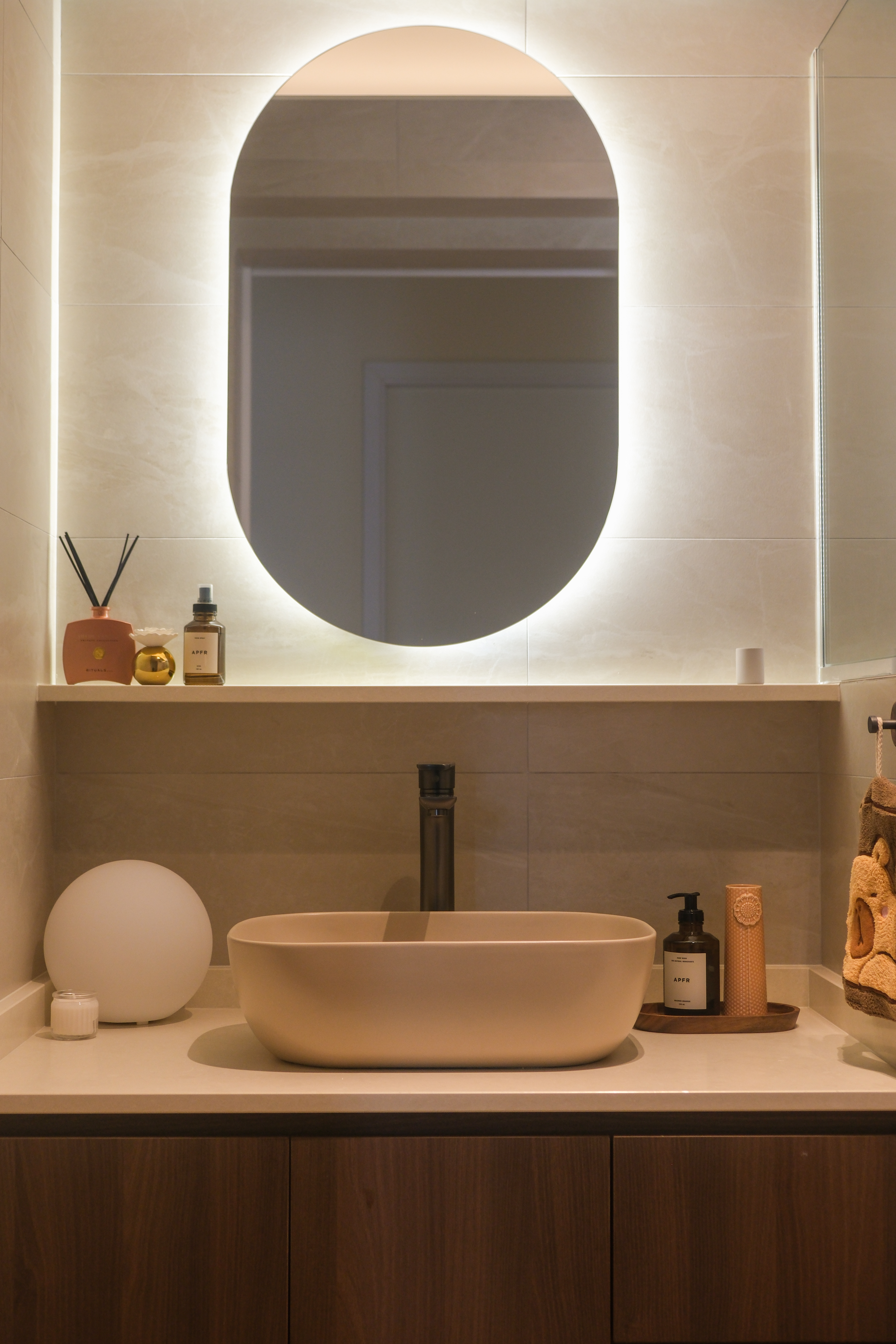 Minimalist Japandi Elegance. Warm tones and natural light.  - Modern bathroom vanity, minimalist design, oval mirror, soft