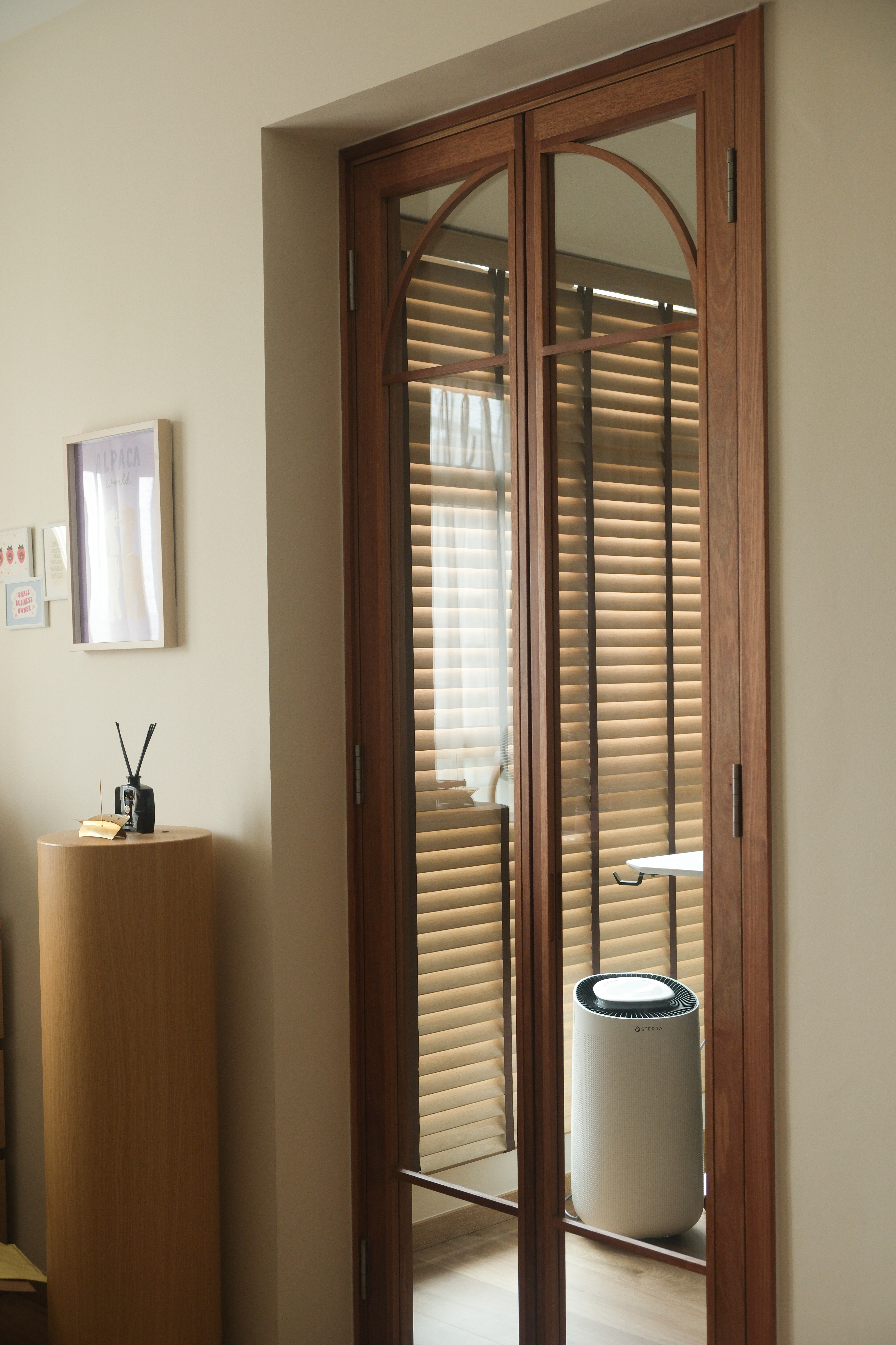 Minimalist Japandi Elegance. Warm tones and natural light.  - Wooden-framed glass doors, modern interior, minimalist decor