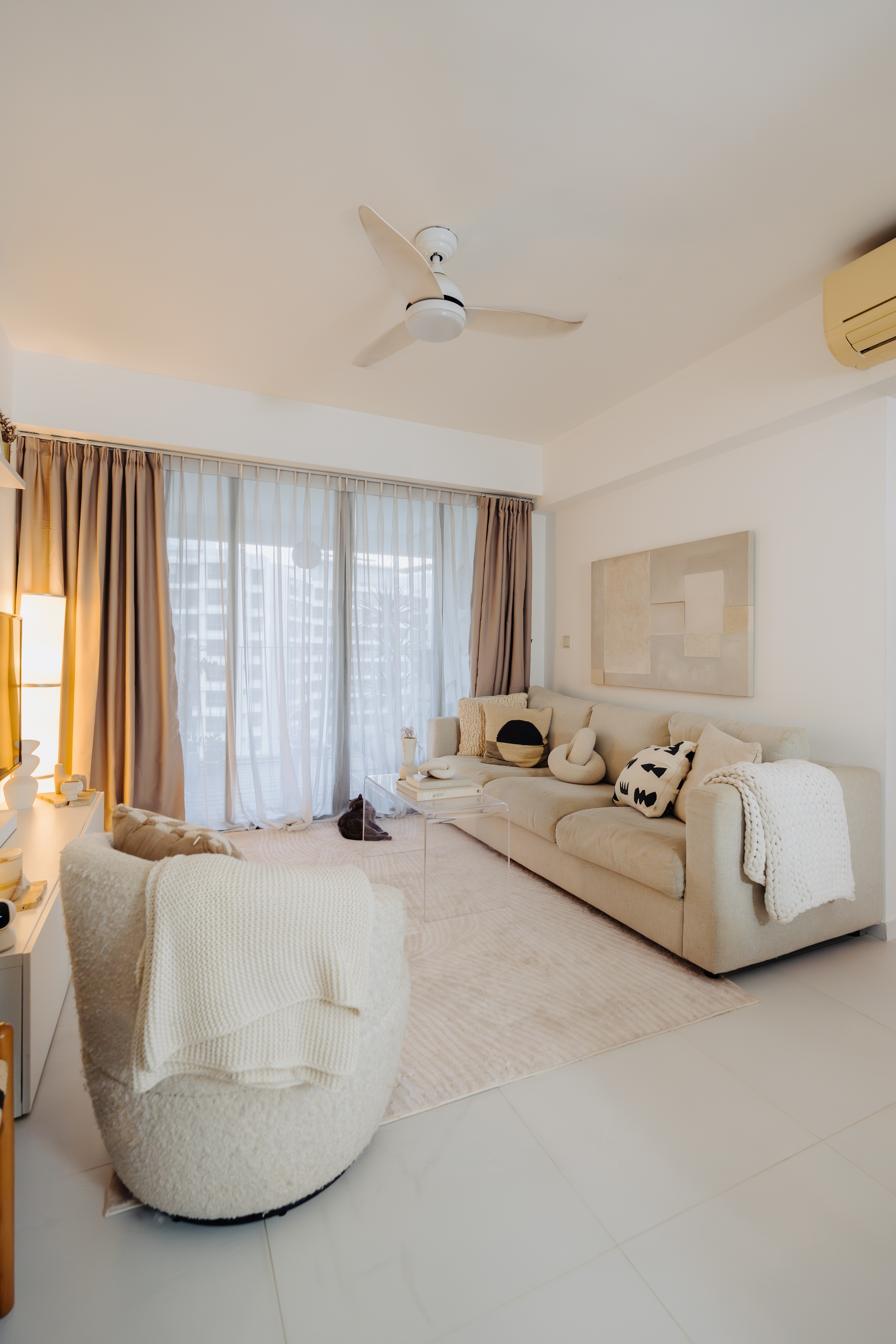 Before & After: Our Living Room During Different Eras Of Our Lives - Modern living room with beige sofa, abstract painting