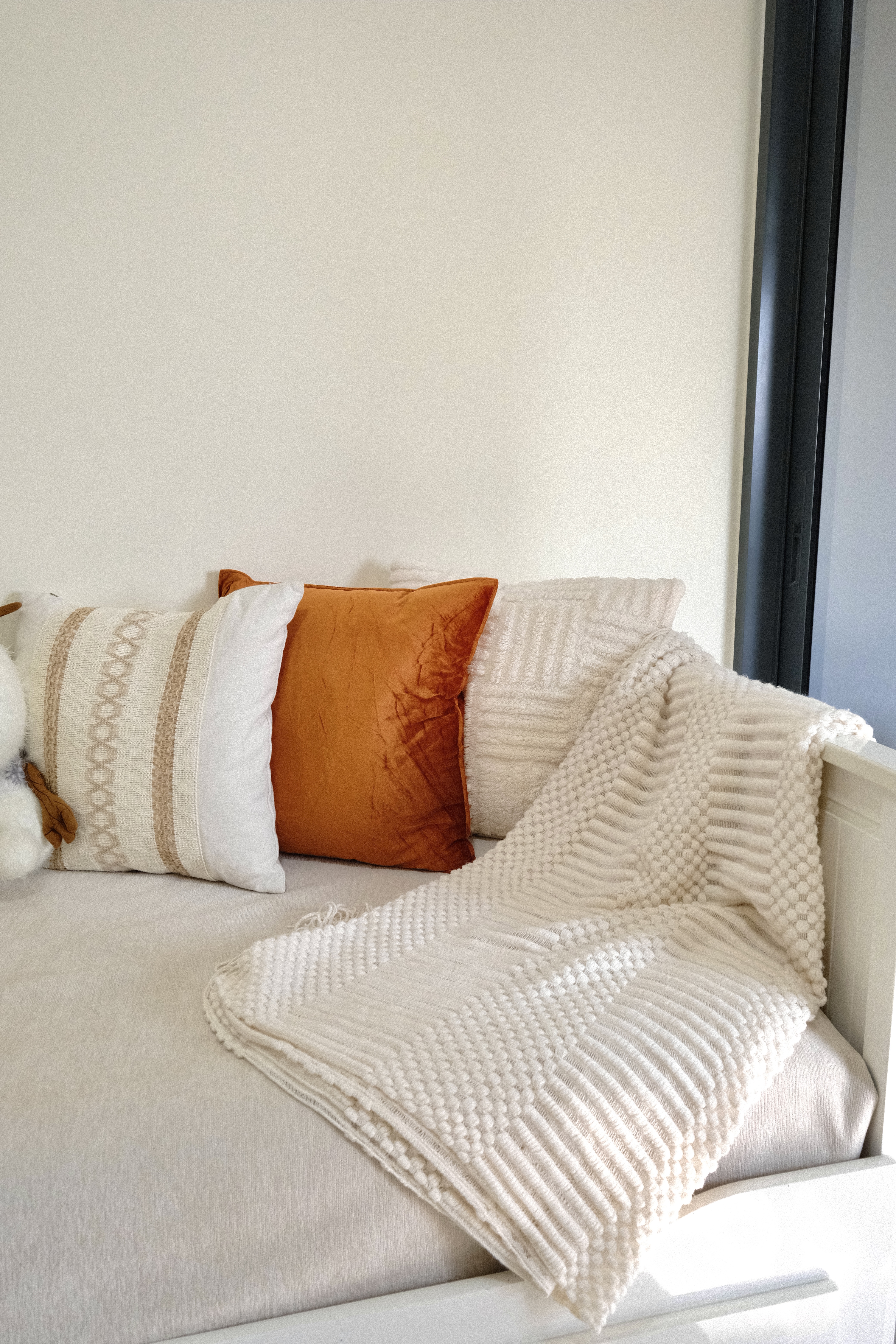 Inviting you to step into our favorite haven in the house! ✨ - Cream-colored, textured throw blanket, cozy pillows, white and