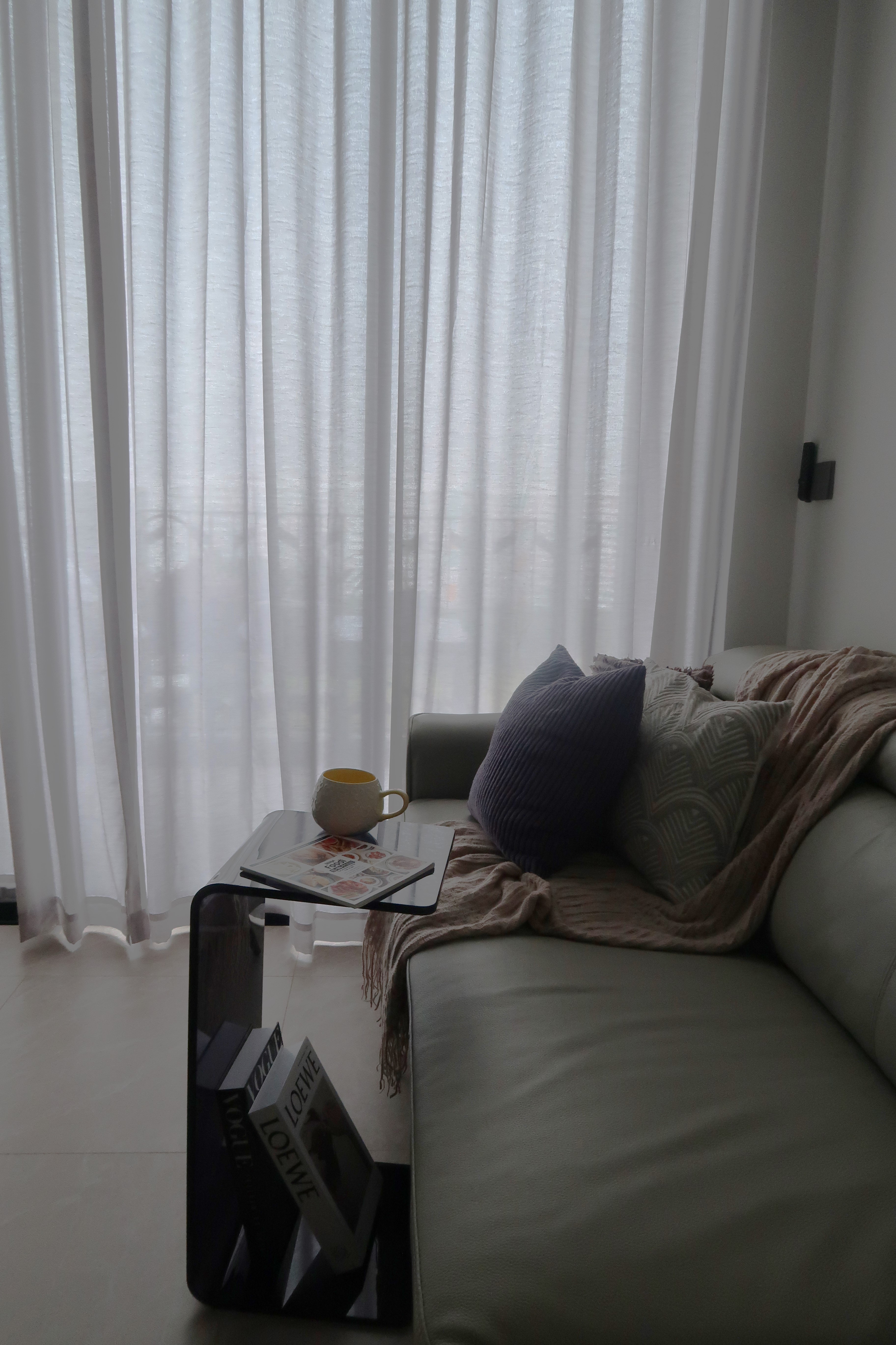 Simple and Sleek High Ceiling Living Room: Modern Dark Loft at North - White sheer curtains softly filter natural light