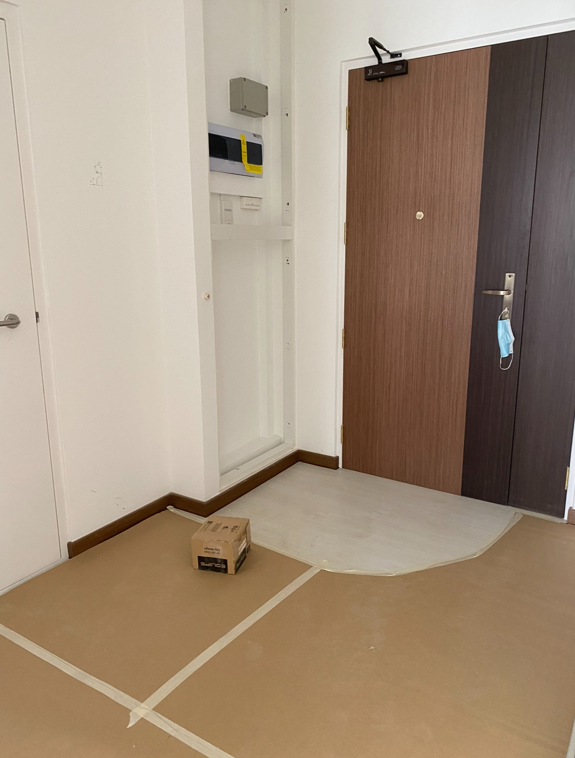 Before and After: All about the Details! - Wooden door, cardboard box, taped floor, white walls, brown door, utility box