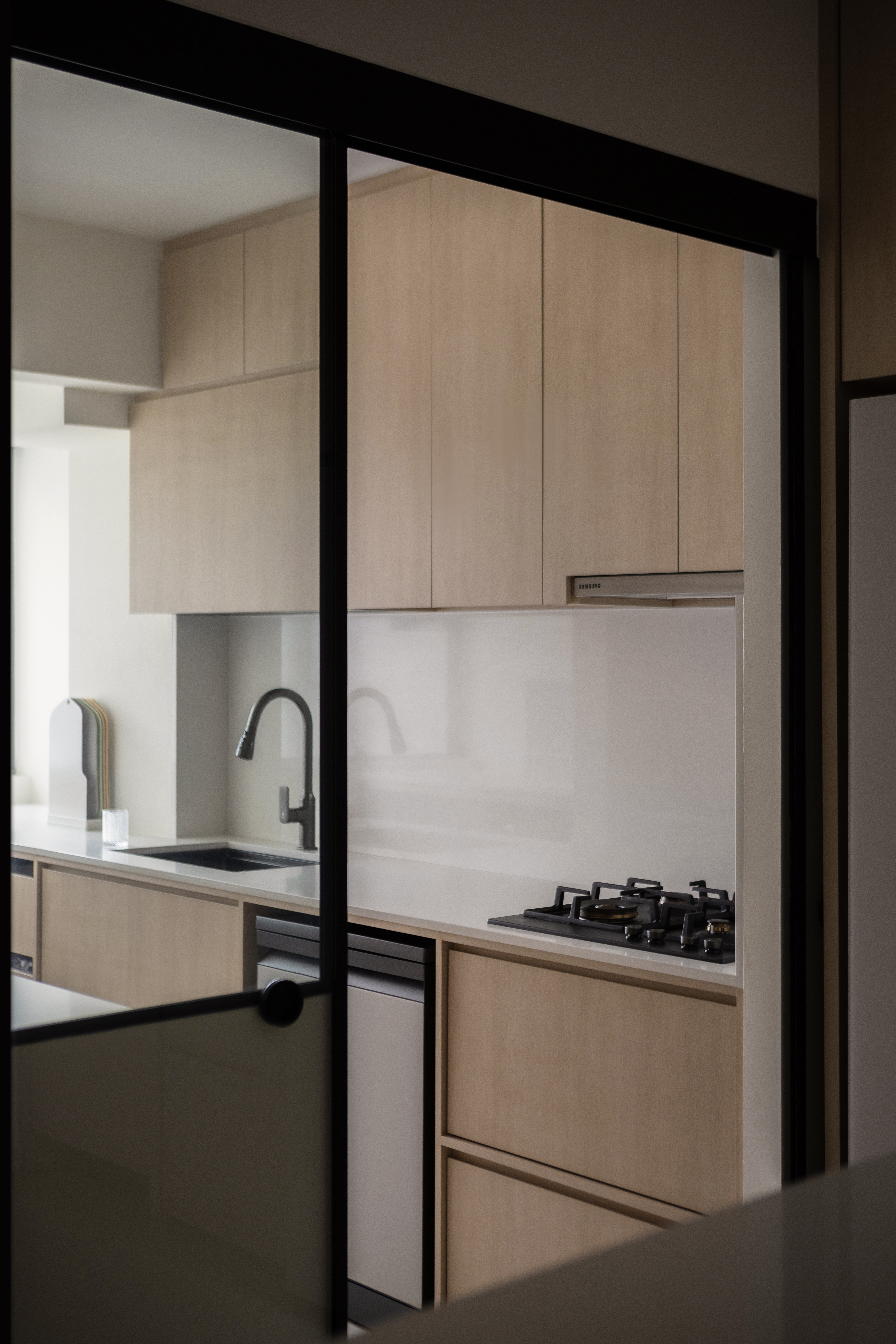 Our Kitchen: A neutral affair premised by the 60-30-10 theory  - Modern kitchen with sleek design, light wood cabinets