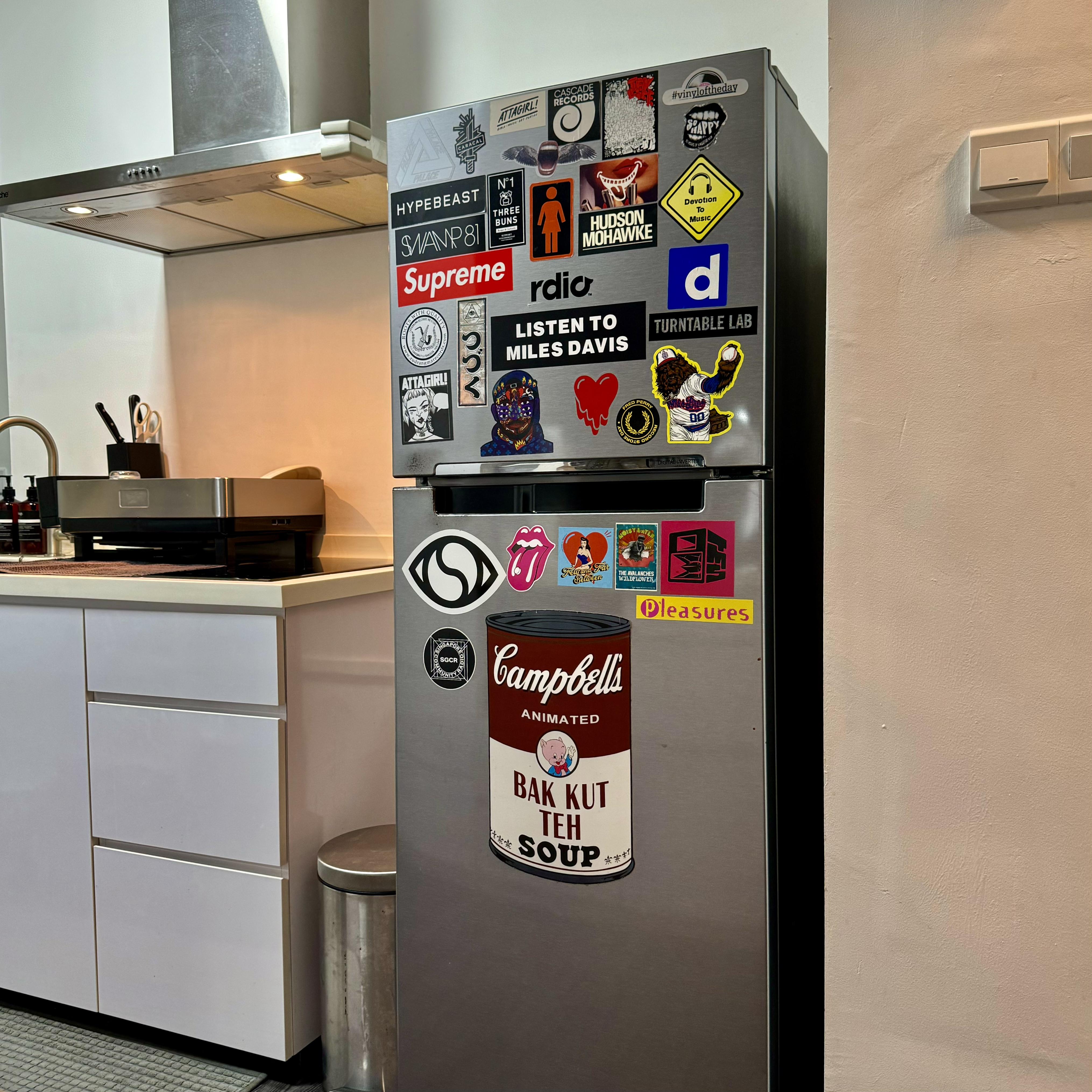 Simplicity in Style: A Tour of Our Minimalist Kitchen with A Twist - Magnetic refrigerator adorned with various stickers